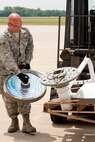 Senior Airman Joseph Hudson, a member of the 76th Aerial Port Squadron here, supports fragile medical equipment being loaded onto a pallet for transport to Honduras. Provided by local charity Mission of Love, the items are scheduled to be shipped via a KC-10 provided by the 514th Air Mobility Wing, Joint Base McGuire-Dix-Lakehurst, New Jersey. The mission was arranged using the Denton program, which allows private U.S. citizens and organizations to use space available on U.S. military cargo planes to transport humanitarian goods, such as clothing, food, medical and educational supplies, and agricultural equipment and vehicles, to countries in need. 