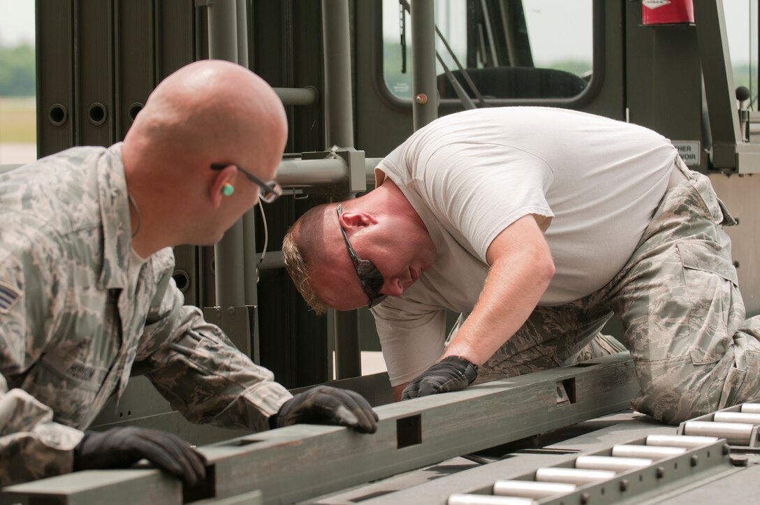 Air Force Reserve Master Sergeant Kevin Massie and Senior Airman Joseph Hudson, both members of the 76th Aerial Port Squadron, prepare a K-loader to receive pallets of medical equipment and supplies, school furniture, clothes and other donated items for transport to Honduras. Provided by local charity Mission of Love, the items are scheduled to be shipped via a KC-10 provided by the 514th Air Mobility Wing, Joint Base McGuire-Dix-Lakehurst, New Jersey. The mission was arranged using the Denton program, which allows private U.S. citizens and organizations to use space available on U.S. military cargo planes to transport humanitarian goods, such as clothing, food, medical and educational supplies, and agricultural equipment and vehicles, to countries in need. 