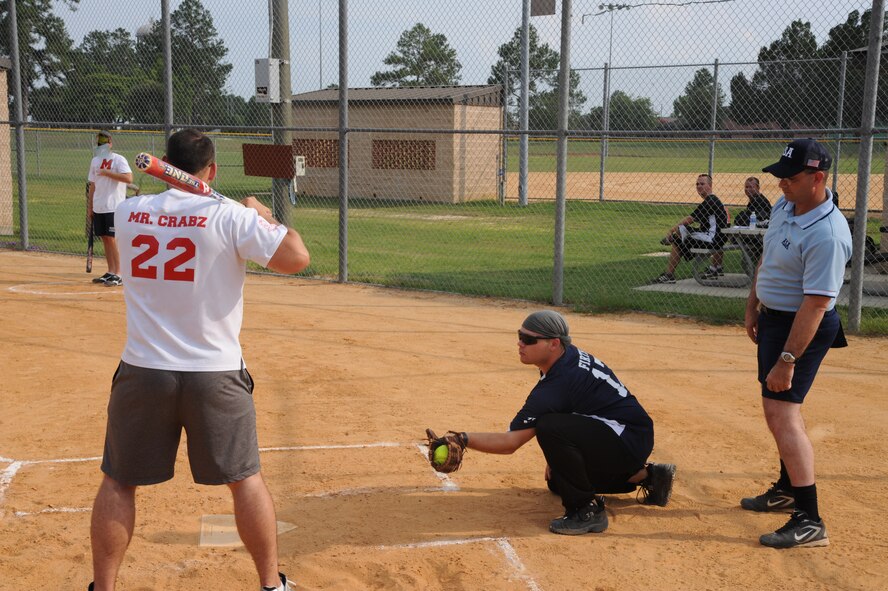 Patrick Mills, 23rd Component Maintenance Squadron, watches as Justin Firth, 723rd Aircraft Maintenance Squadron, catches a pitch during the final softball game of the regular season at Moody Air Force Base, Ga., July 6, 2011. The throw was called a strike, sending Mills back to the dugout with two men on base. (U.S. Air Force photo by Airman 1st Class Paul Francis/Released)