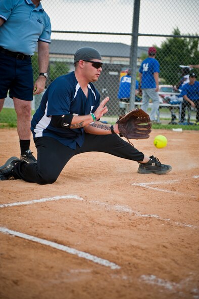 Justin Firth, 723rd Aircraft Maintenance Squadron, catches a pitch during an intramural softball game against the 23rd Component Maintenance Squadron at Moody Air Force Base, Ga., July 6, 2011. The game was the third meeting of the season for the teams with them each splitting the first two. The 723rd won the game 12-3. (U.S. Air Force photo by Jamal D. Sutter/Released)