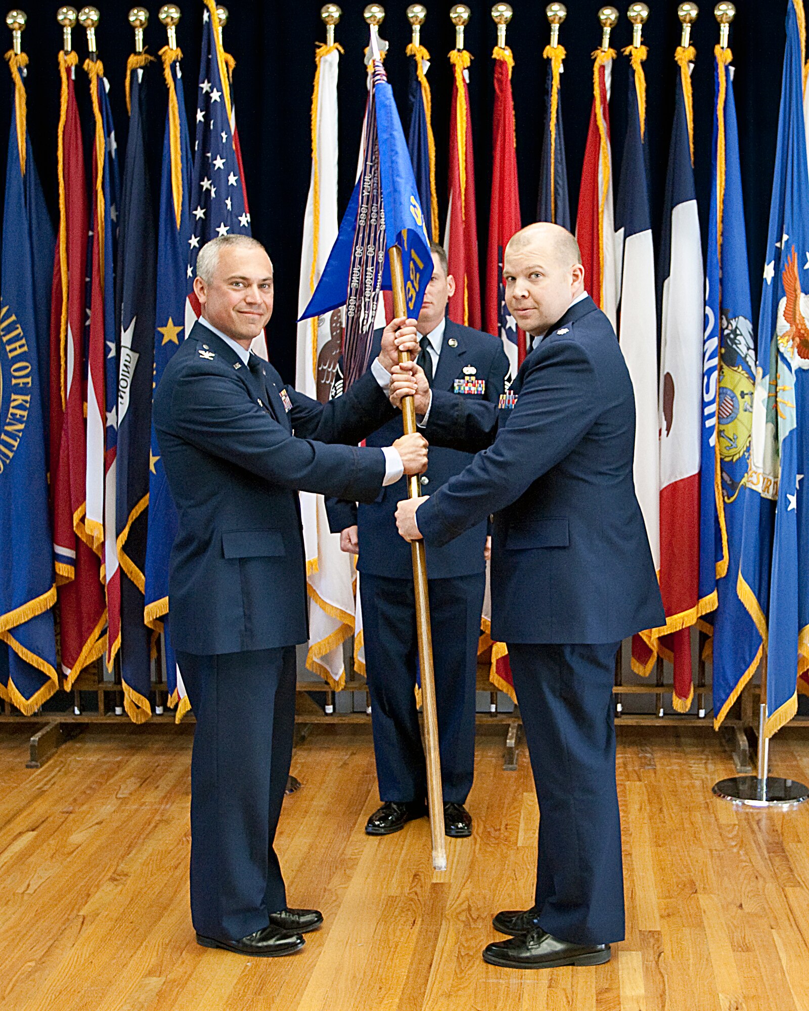 Lt. Col. Matthew Dillow, 321st Missile Squadron commander, accepts the guidon from Col. Robert Vercher, 90th Operations Group commander, during the 321st MS change-of-command ceremony at the Pronghorn Center June 24. (U.S. Air Force photo by Blaze Lipowski)