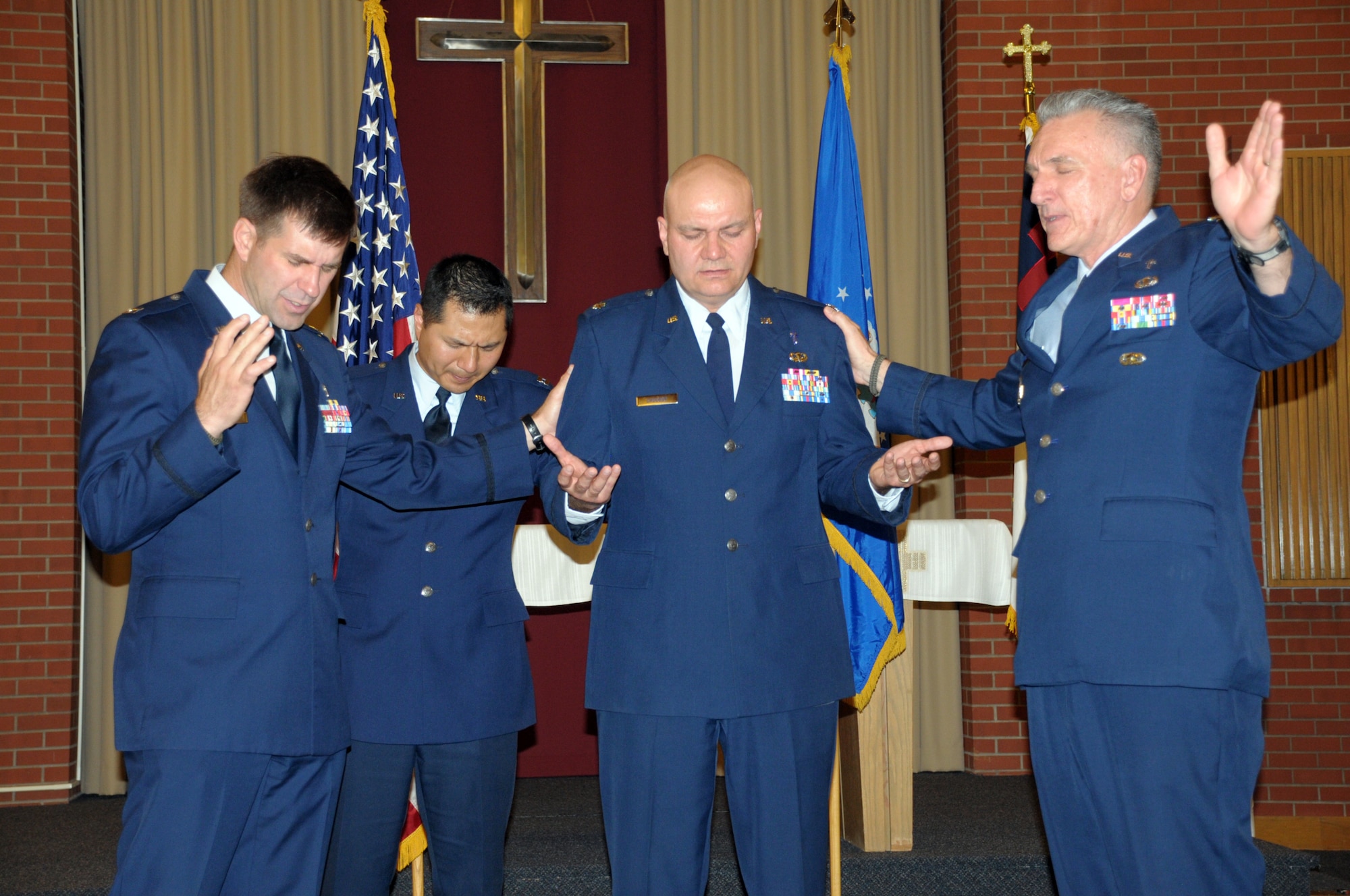 Chaplain (Lt. Col.) Alan Chouest, 90th Missile Wing chaplain, was promoted June 30 in the High Plains Chapel. Chaplain (Col.) Gregory Tate, Air Force Air Combat Command chaplain, officiated and Chaplain (Capt.) Bradley Kimble and Chaplain (Capt.) Myung Cho, 90th MW Chaplains Office participated  in the promotion ceremony. (U.S. Air Force photo by Blaze Lipowski)