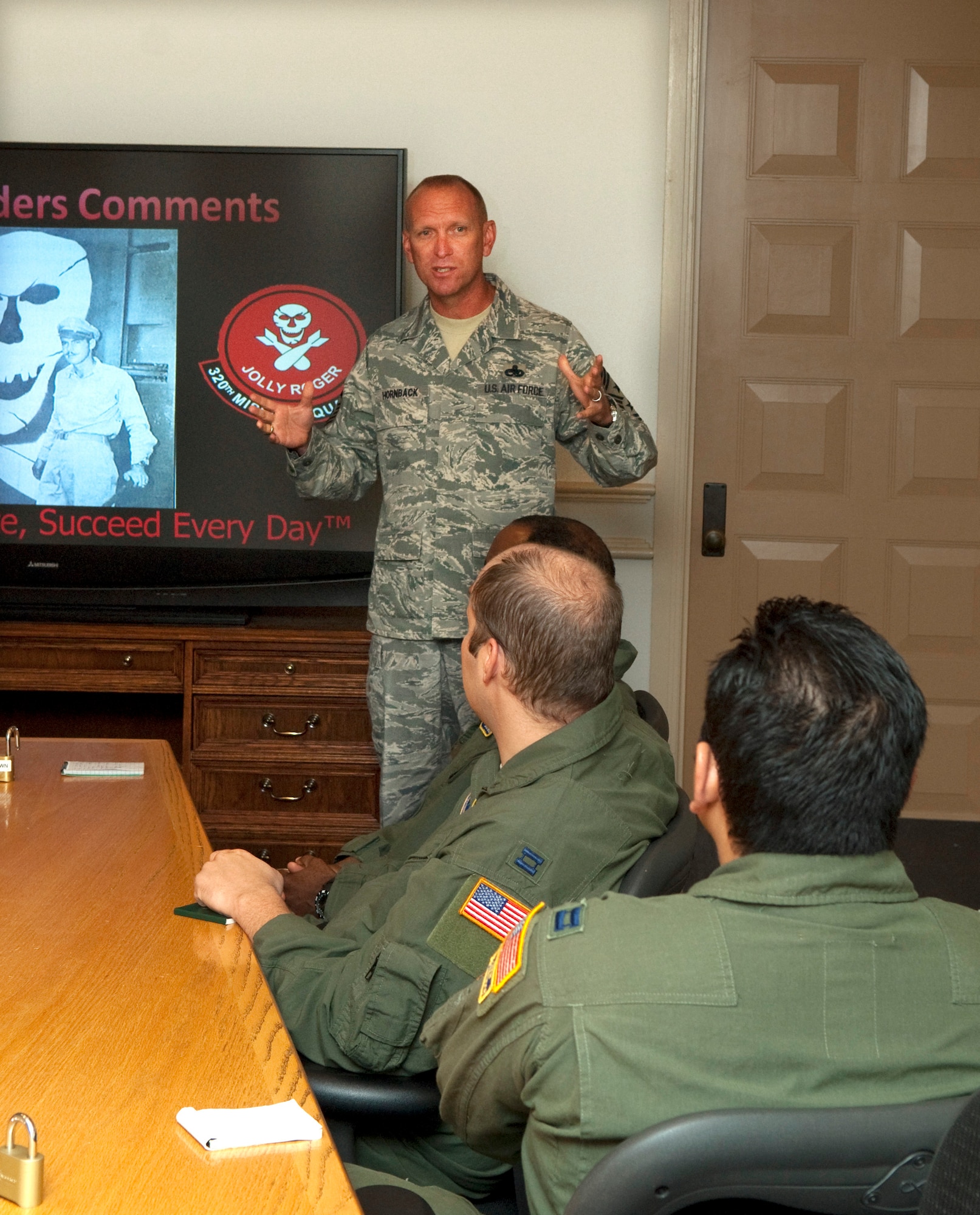 Chief Master Sgt. Brian Hornback, Air Force Global Strike Command command chief, talks with members of the 320th Missile Squadron before they post out to the missile field Thursday. (U.S. Air Force photo by R.J. Oriez)