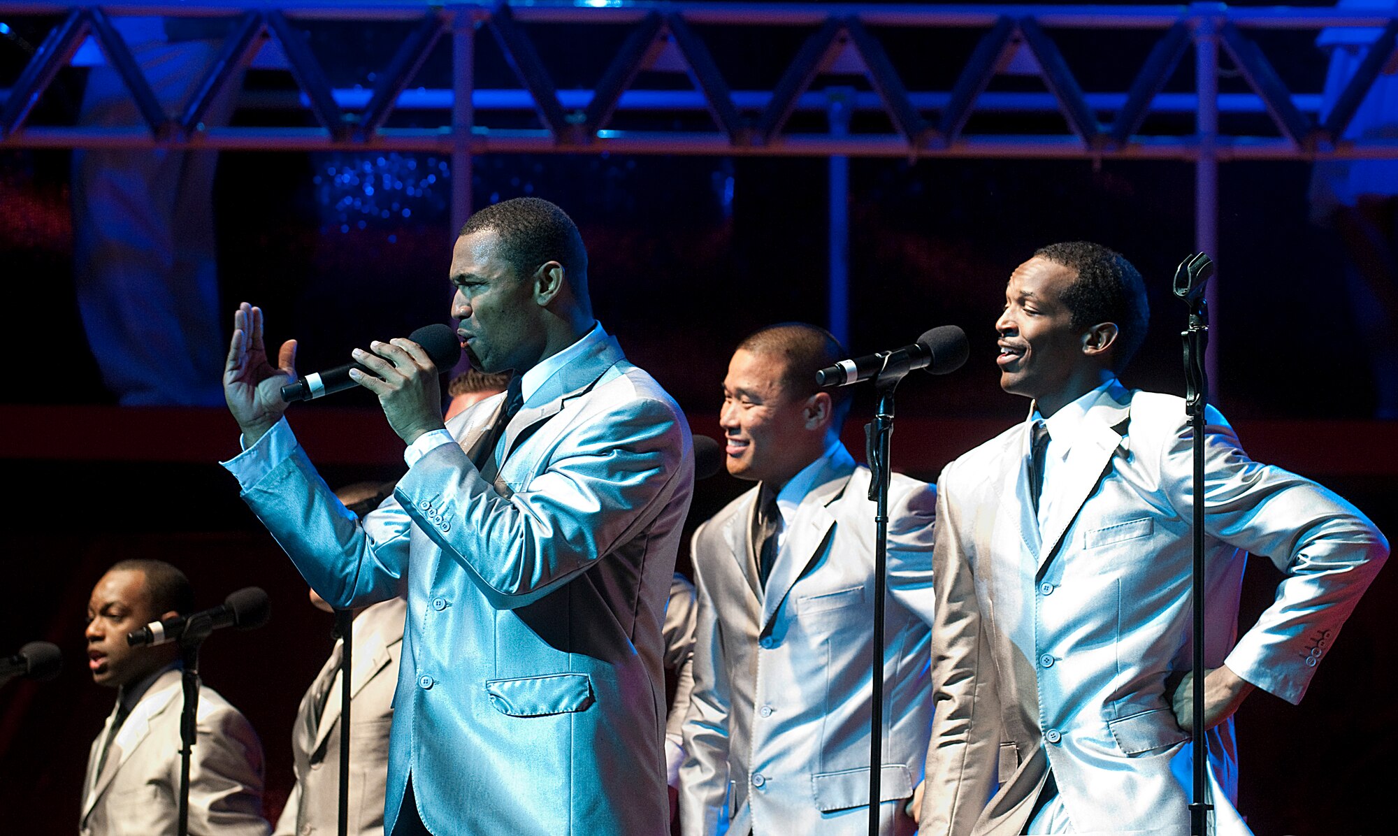 F. E. Warren AFB’s own Airman 1st Class Jarrod Burton sings lead during a number with the Air Force’s entertainment troupe “Tops in Blue” at their performance in Frontier Park Arena in Cheyenne Monday as part of the city’s Fourth of July celebration. (U.S. Air Force photo by R.J. Oriez)