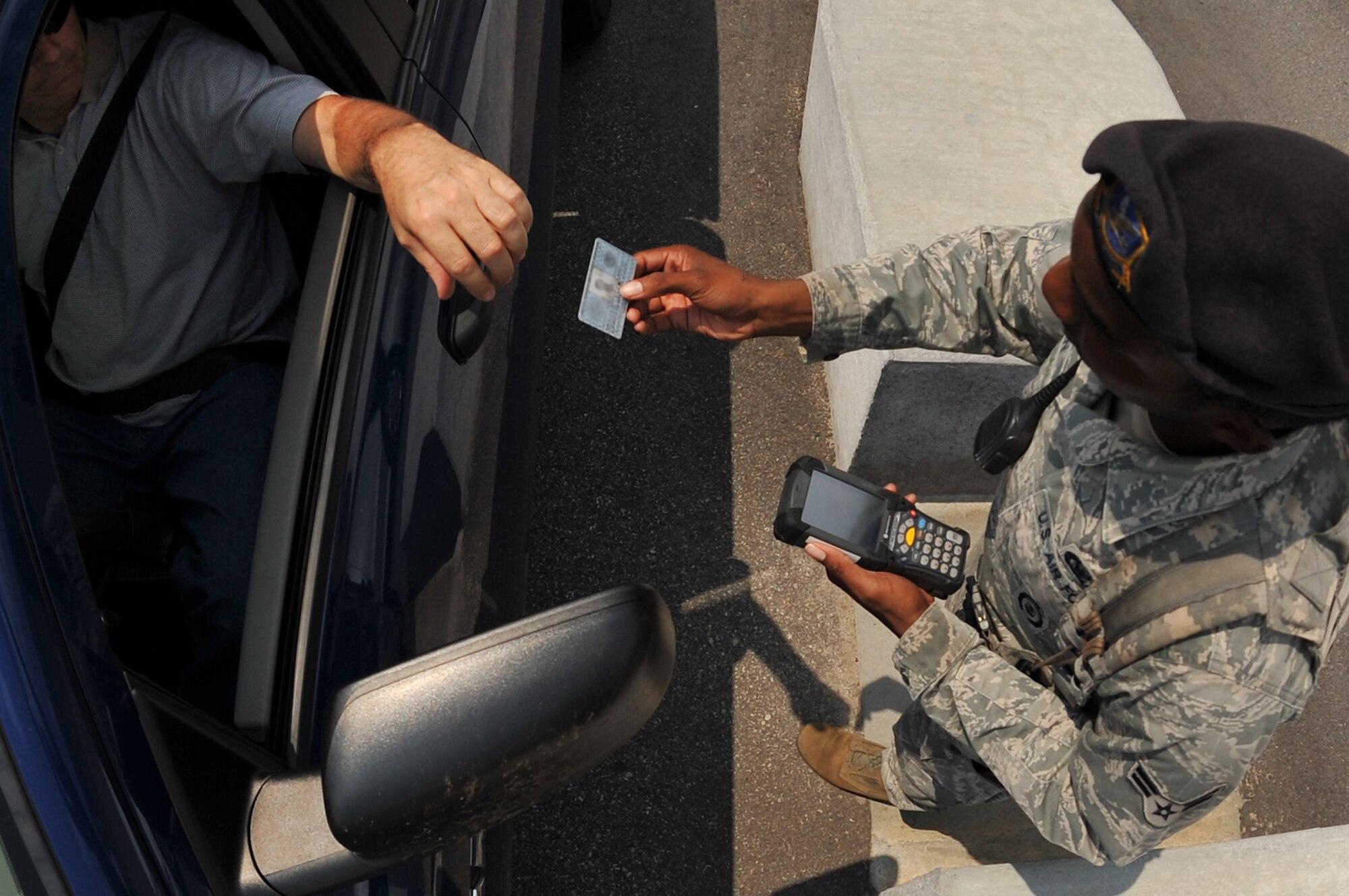 SHAW AIR FORCE BASE, S.C. -- Airman 1st Class Justin Holman, 20th Security Forces Squadron member, scans IDs with the new Defense Biometric Identification System at the gate here July 7, 2011. DBIDS is a Department of Defense system developed as a force protection and identity management program to manage personnel, property and installation. The SFS is urging everyone to get registered or risk being turned away at the gate. (U.S. Air Force photo by Senior Airman Kenny Holston)
