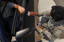SHAW AIR FORCE BASE, S.C. -- Airman 1st Class Justin Holman, 20th Security Forces Squadron member, scans IDs with the new Defense Biometric Identification System at the gate here July 7, 2011. DBIDS is a Department of Defense system developed as a force protection and identity management program to manage personnel, property and installation. The SFS is urging everyone to get registered or risk being turned away at the gate. (U.S. Air Force photo by Senior Airman Kenny Holston)
