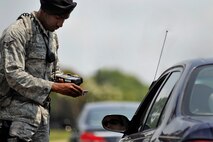 SHAW AIR FORCE BASE, S.C. -- Airman 1st Class Justin Holman, 20th Security Forces Squadron member, scans IDs with the new Defense Biometric Identification System at the gate here July 7, 2011. DBIDS is a Department of Defense system developed as a force protection and identity management program to manage personnel, property and installation. The SFS is urging everyone to get registered or risk being turned away at the gate. (U.S. Air Force photo by Senior Airman Kenny Holston)
