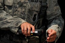 SHAW AIR FORCE BASE, S.C. - Senior Airman Ryan Kelly, 20th Security Forces Squadron member, scans IDs with the new Defense Biometric Identification System at the gate here July 7, 2011. DBIDS is a Department of Defense system developed as a force protection and identity management program to manage personnel, property and installation. The SFS is urging everyone to get registered or risk being turned away at the gate. (U.S. Air Force photo by Senior Airman Kenny Holston)
