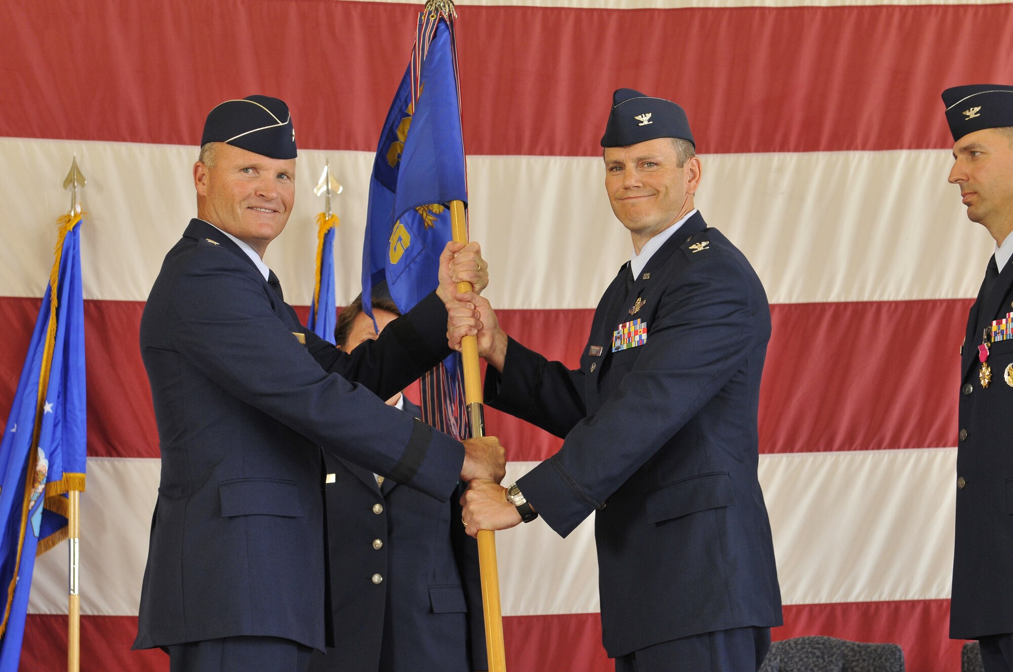 Brigadier Gen. James S. Browne, 325th Fighter Wing commander, passes command of the 325th Operations Group to Col. Charles Corcoran during a change of command ceremony July 7. Colonel Corcoran replaces Col. Wesley Hallman who departs Tyndall for a deployment. Colonel Corcoran arrives from Washington D.C., where he attended the National War College, Fort Lesley J. McNair. (U.S. Air Force photo by Lisa Norman)