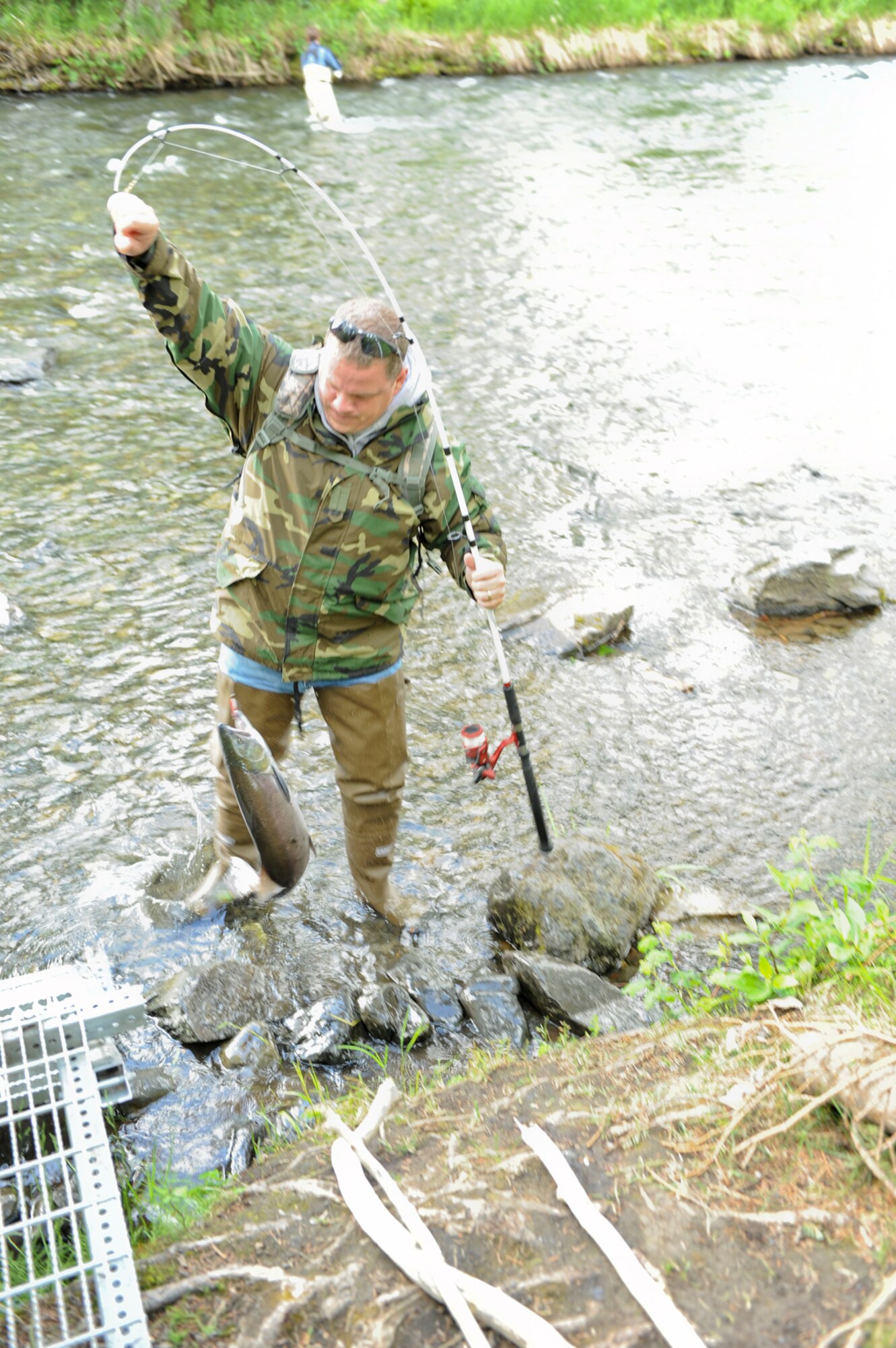 Air Force Master Sgt. Michael Hapgood, on temporary duty at Joint Base Elmendorf-Richardson from the 72nd Aerial Port Squadron at Tinker Air Force Base, Okla., brings in a red salmon June 27. Hapgood participated in the 673d Force Support Squadron/Morale Welfare and Recreation fi shing trip to the Russian River, near Cooper Landing, Alaska, on the Kenai Peninsula. (U.S. Air Force photo/Steve White)