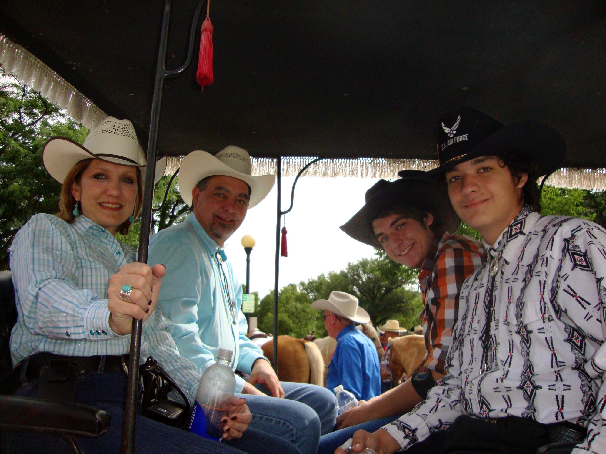 Chief Master Sgt. Tammy Elliott, 20th Air Force command chief, rides in a wagon with her family during a parade for Cheyenne Frontier Days 2010. (Courtesy photo)