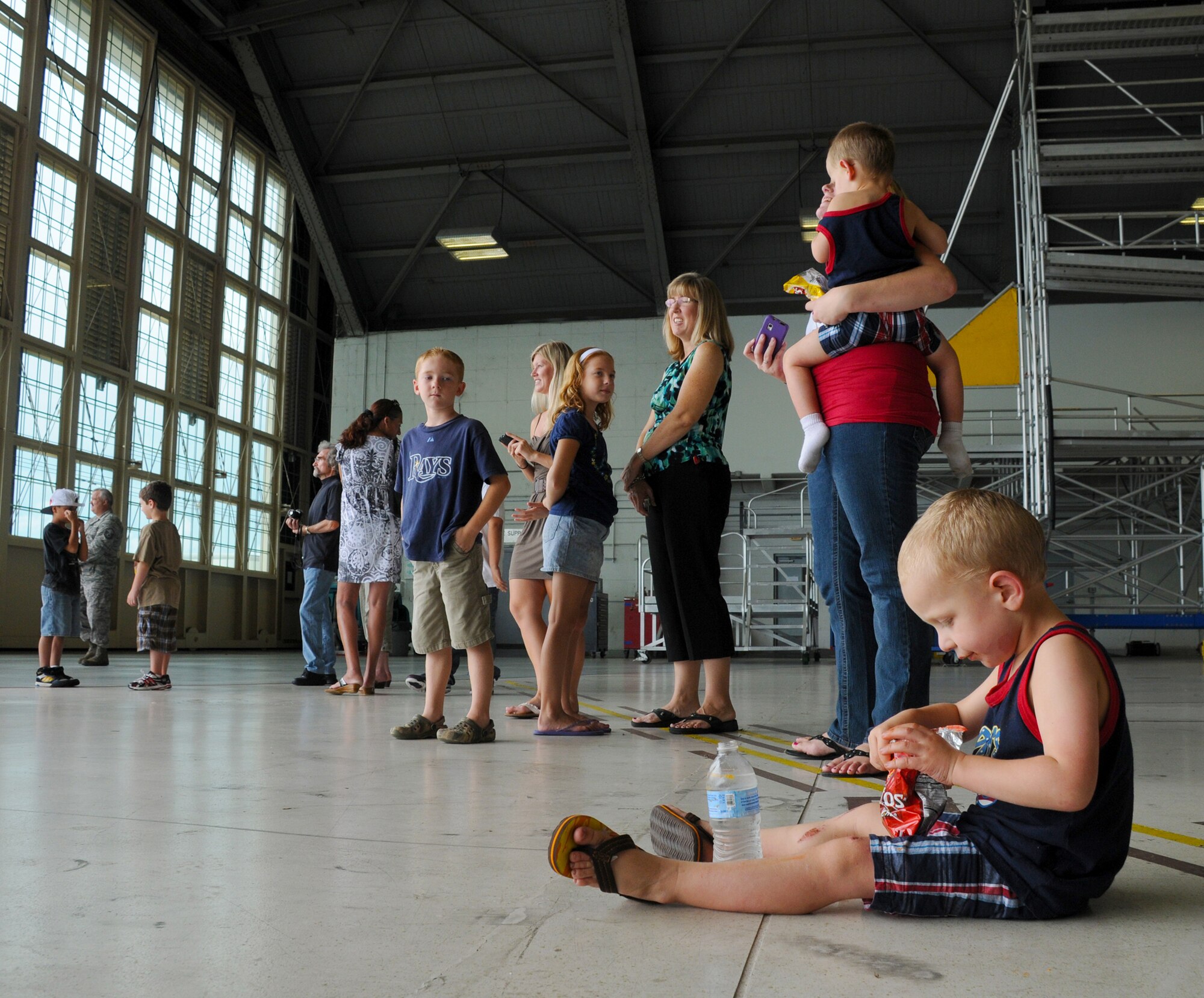 MacDill Air Force Base, Fla. --   Logan Dougherty sits and makes use of his free time while waiting for his father to arrive on the runway outside the hangar. His father, Senior Airman Robert Dougherty, is a reservist with the 927th Air Refueling Wing here.  The Lakeland native left his wife, two sons and job in the Tampa community to serve his country with the 90th Expeditionary Air Refueling Squadron. (Official U.S. Air Force photo by Staff Sgt. Shawn Rhodes)