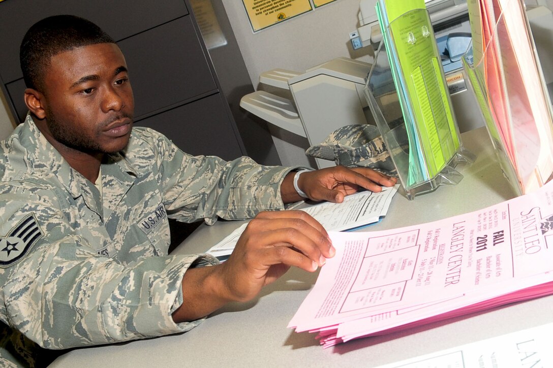 Staff Sgt. Soloman Jones, 633rd Aeromedical Squadron health service manager, looks at a Saint Leo University fall schedule at the Education Center at Langley Air Force Base, Va., July 7, 2011. The education center provides classes, assistance with course and program selections, and information on all options available for retired and active duty military. (U.S. Air Force photo by SSgt Ashley Hawkins/Released)