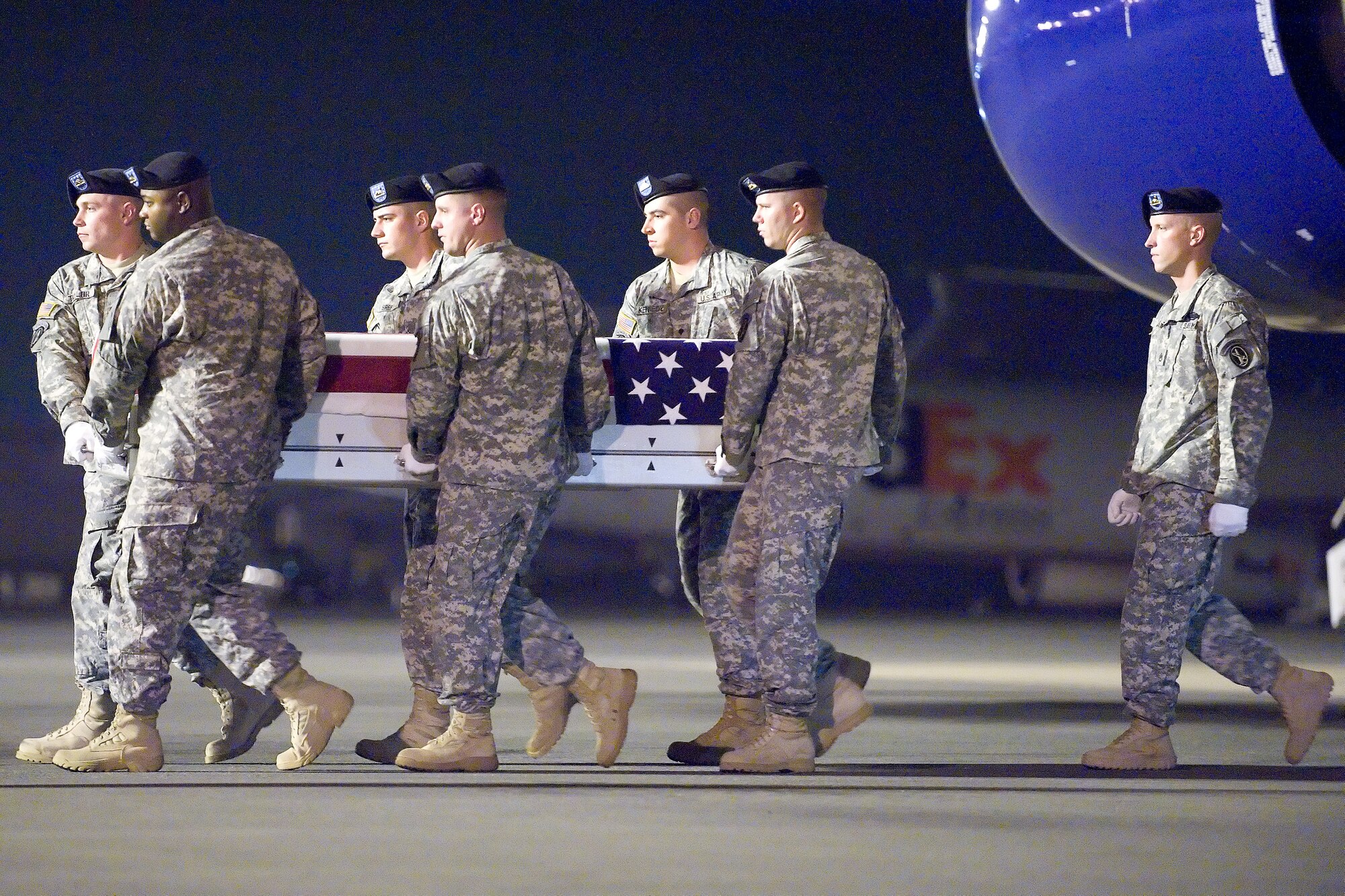 A U.S. Army carry team transfers the remains of Army Sgt. Nicanor Amper IV, of San Jose, Calif., at Dover Air Force Base, Del., July 7, 2011. Amper was assigned to Troop A, 6th Squadron, 4th Cavalry, 3 Brigade Combat Team, Ft. Knox, Ky. (U.S. Air Force photo/Adrian Rowan)