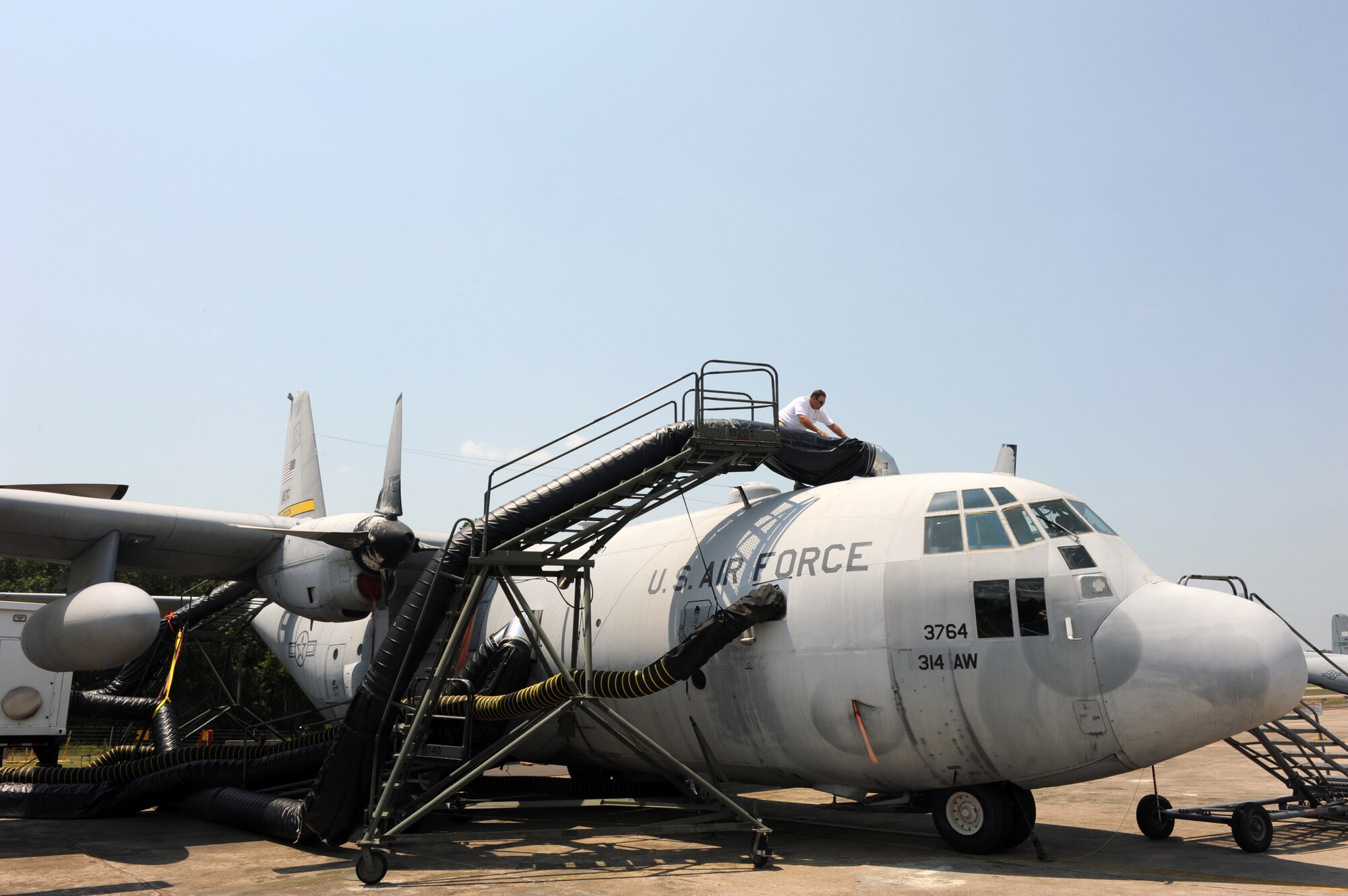 William Dunn, a contractor, checks the connection points of a decontamination duct on a C-130 on July 6, 2011, at Little Rock Air Force Base, Ark. The decontamination duct supplies hot humid air to the aircraft to determine how heat and humidity affect the decontamination process for an aircraft contaminated with a simulated biological agent. (U.S. Air Force photo by Airman 1st Class Rusty Frank) 