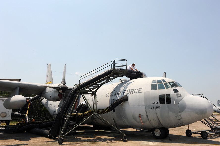 William Dunn, a contractor, checks the connection points of a decontamination duct on a C-130 Hercules July 6, 2011, at Little Rock Air Force Base, Ark. The decontamination duct supplies hot, humid air to the aircraft to determine how heat and humidity affect the decontamination process for an aircraft contaminated with a simulated biological agent. (U.S. Air Force photo/Airman 1st Class Rusty Frank)