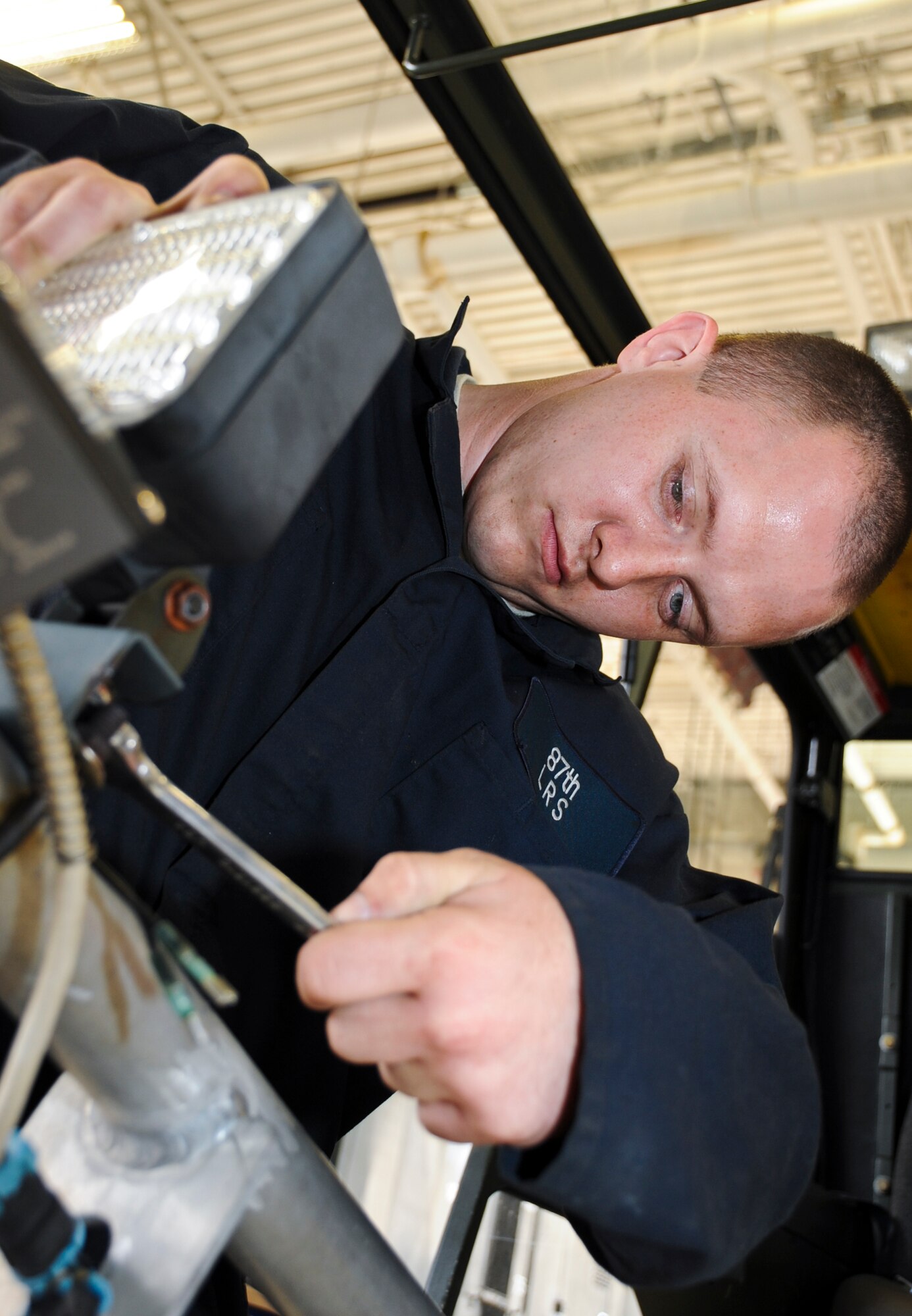 JOINT BASE MCGUIRE-DIX-LAKEHURST, N.J. -- Airman 1st Class Jonathan
Ryan, 87th Logistics Readiness Squadron, tightens a bolt on a light fixture on an aircraft de-icer at the 87th LRS vehicle maintenance shop June 14. Ryan has been assigned to the LRS for one year. (U.S. Air Force photo by Senior Airman David Carbajal/Released)

