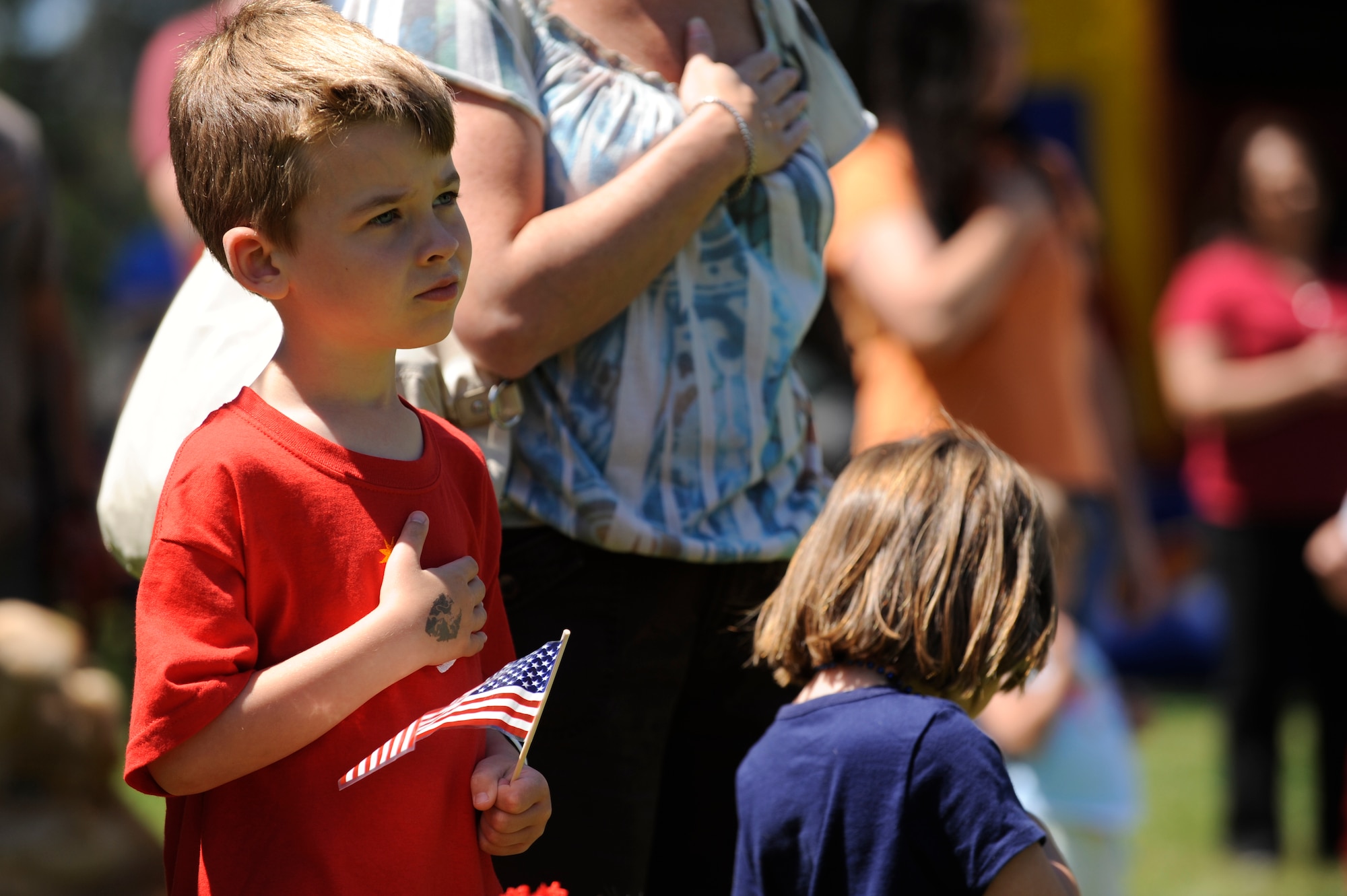 VANDENBERG AIR FORCE BASE, Calif. -- A boy holds his hand over his heart during the singing of the National Anthem for an Independence Day picnic at Cocheo park here Saturday, July 2, 2011.  (U.S. Air Force photo/Staff Sgt. Andrew Satran) 

 
  