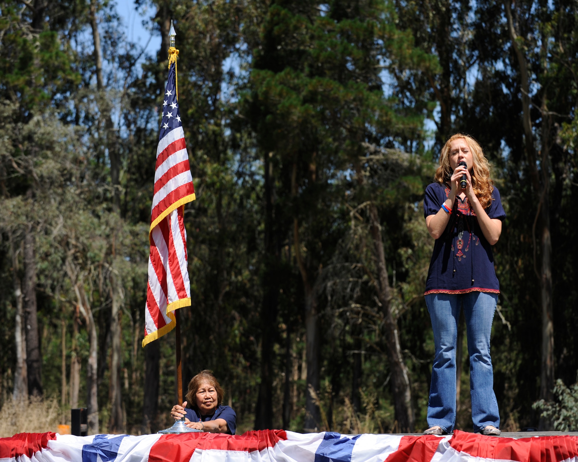 VANDENBERG AIR FORCE BASE, Calif. -- Emily Silva, a 30th Force Support Squadron member, sings the National Anthem during an Independence Day picnic at Cocheo park here Saturday, July 2, 2011.  Team V members ate food and participated in games during the event.  (U.S. Air Force photo/Staff Sgt. Andrew Satran) 

  