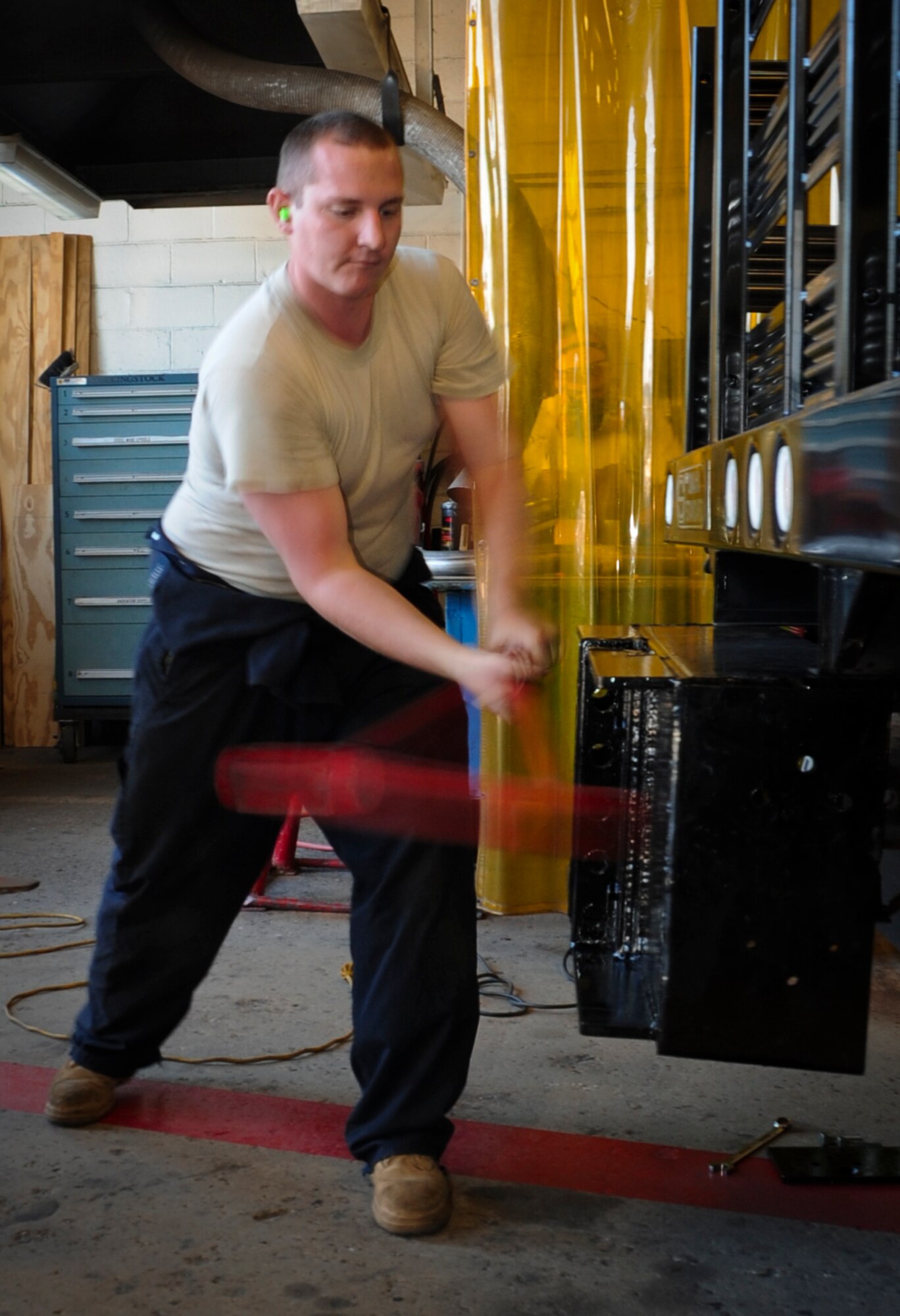 JOINT BASE MCGUIRE-DIX-LAKEHURST, N.J. -- Senior Airman Aaron Waldor, 87th Logistics Readiness Squadron, pounds a hitch onto a truck with a sledge hammer at the 87th LRS vehicle maintenance shop June 14. Waldor has been assigned to the 87th LRS for two-and-a-half years. (U.S. Air Force photo by Airman 1st Class Dennis Sloan/Released)