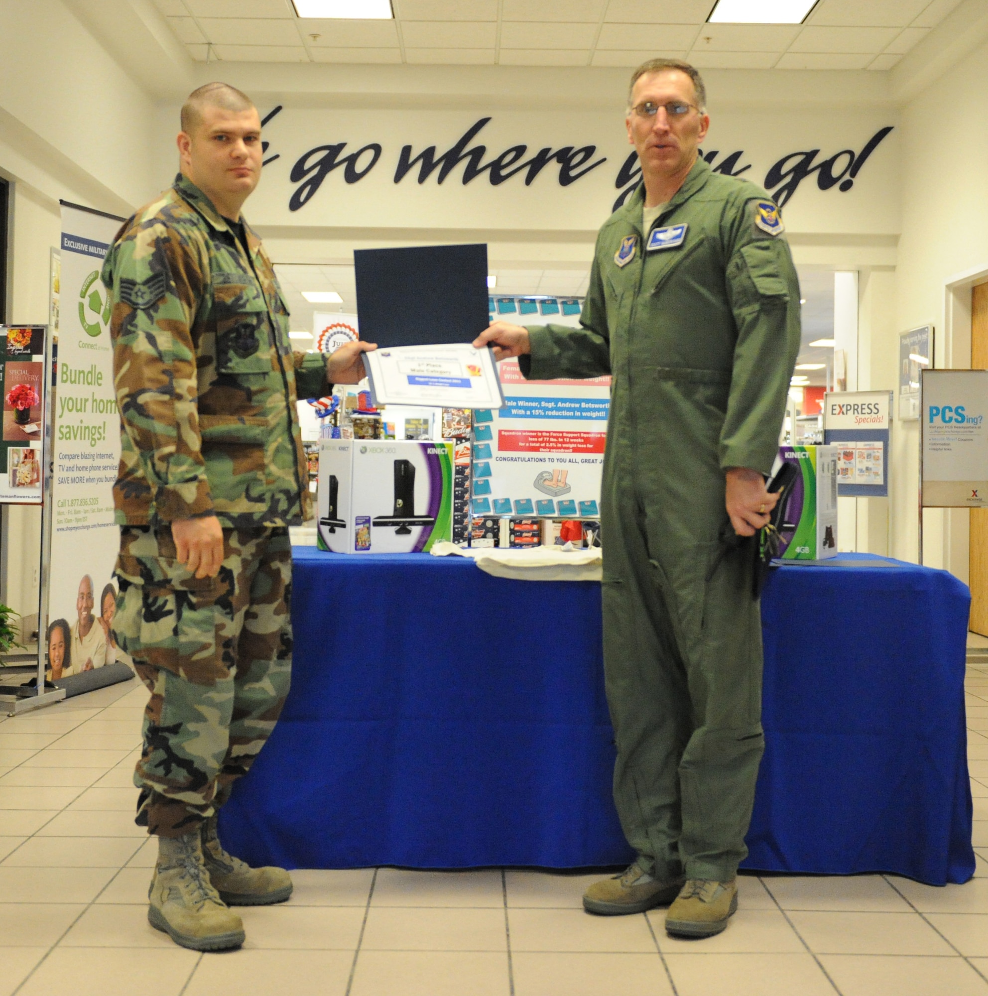 WHITEMAN AIR FORCE BASE, Mo. -- Brig. Gen. Scott Vander Hamm, 509th Bomb Wing commander, presents Staff Sgt. Andrew Betsworth, 509th Maintenance Group with a certificate for earning the Winner of the Top Male Loser category with a percentage weight loss of 15.03 percent. Machelle Cotton, 509th Comptroller Squadron, earned the Top Female Winner Category with a body fat percentage weight loss of 17.02 percent (not pictured). The 509th Force Support Squadron won the squadron competition with 77 pound weight loss. The competition was sponsored by the HAWC, 509th MDG. (U.S. Air Force photo by 509th Bomb Wing Public Affairs)