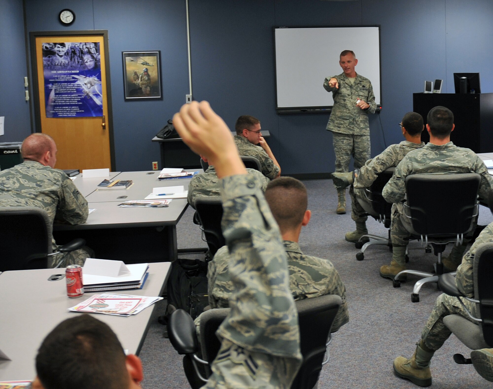 Air Force Chief Master Sgt. Jeffry Helm, Army & Air Force Exchange senior enlisted advisor, spoke to Airmen at the First Term Airmen Center on June 23, 2011 at Offutt Air Force Base, Neb.  Chief Master Sgt. Helm engaged Airmen, asking them questions about food service throughout the different bases around the world and awarding them with prizes for the correct answer. Chief Master Sgt. Helm is visiting bases throughout the world to find out what the Exchange can do to better serve its customers and fix existing problems. (U.S. Air Force photo by Jeff W. Gates/Released)