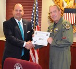 LAUGHLIN AIR FORCE BASE, Texas – Pete Myers, 47th Flying Training Wing Judge Advocate Office, poses with Col. Michael Frankel, 47th FTW commander, after being presented the XLer of the Week award here June 29. The XLer award is a weekly award chosen by wing leadership and given to those who consistently make outstanding contributions to Laughlin and their unit. (U.S. Air Force photo by Senior Airman Scott Saldukas)