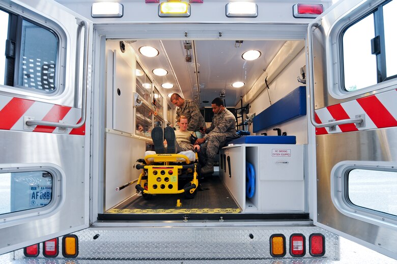 SEYMOUR JOHNSON AIR FORCE BASE, N.C. – Aerospace medical technician Airman 1st Class Jarron Webster, 4th Medical Operations Squadron, right, checks the blood pressure of independent duty medical technician Staff Sgt. Leasa Novotny, 336th Fighter Squadron, during emergency medical technician training in an ambulance at the 4th Medical Group Clinic here June 21, 2011. Aerospace medical technician Senior Airman Shawn Raquet, 4th Medical Operations Squadron, also evaluates Novotny’s blood oxygen content. Medical technicians are required to accomplish 48 hours of continuing medical education every two years that includes hands-on training and lectures. Webster hails from Owensboro, Ky., Novotny hails from Salina, Kan. and Raquet hails from Buffalo, N.Y. (U.S. Air Force photo by Tech. Sgt. Colette M. Graham/Released