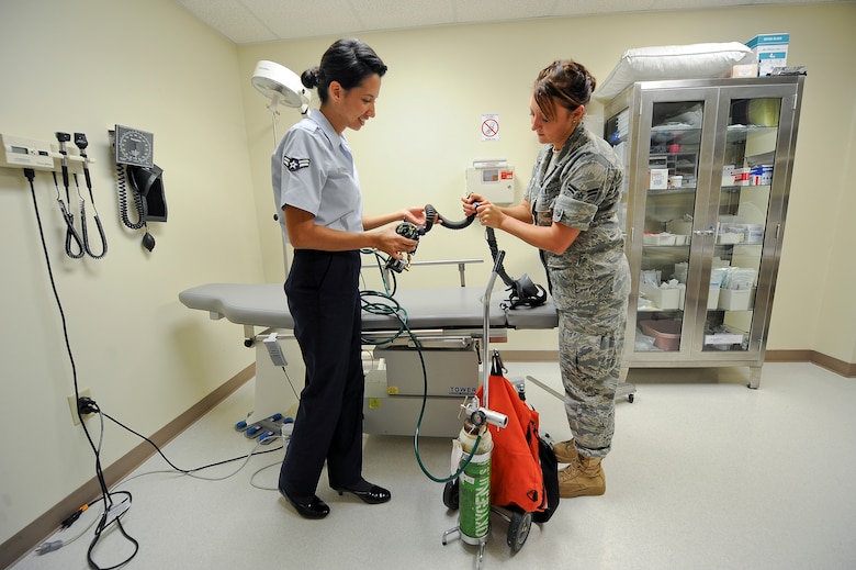 SEYMOUR JOHNSON AIR FORCE BASE, N.C. – Aerospace medical technicians Airmen 1st Class Sarah Rodriguez and Alyse Luchaco, both from the 4th Aerospace Medicine Squadron, inspect an aviator mask using an oxygen tank in the Flight Medicine Clinic here June 20, 2011. Daily inspections are performed on the masks in the event aircrew develops air sickness or have difficulty breathing during flight they can be treated at the clinic. The masks provide 100 percent concentrated oxygen unlike normal oxygen masks and provide forced pressure to push air into the lungs. Rodriguez hails from Brownsville, Texas and Luchaco hails from Homer, Alaska. (U.S. Air Force photo by Tech. Sgt. Colette M. Graham/Released)