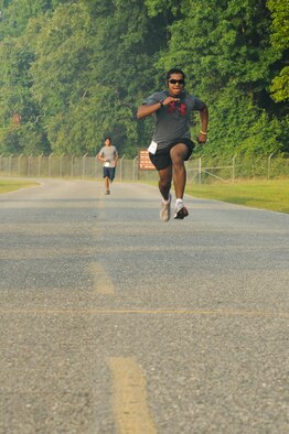 SEYMOUR JOHNSON AIR FORCE BASE, N.C. – Public health technician Senior Airman Husein Khan, 4th Aerospace Medicine Squadron, sprints toward the finish line during the Freedom Run here June 30, 2011. Khan won a T-shirt for placing first in the 5K run; coming in at 22 minutes and hails from Springfield, Va. (U.S. Air Force photo by Tech. Sgt. Colette M. Graham/Released)