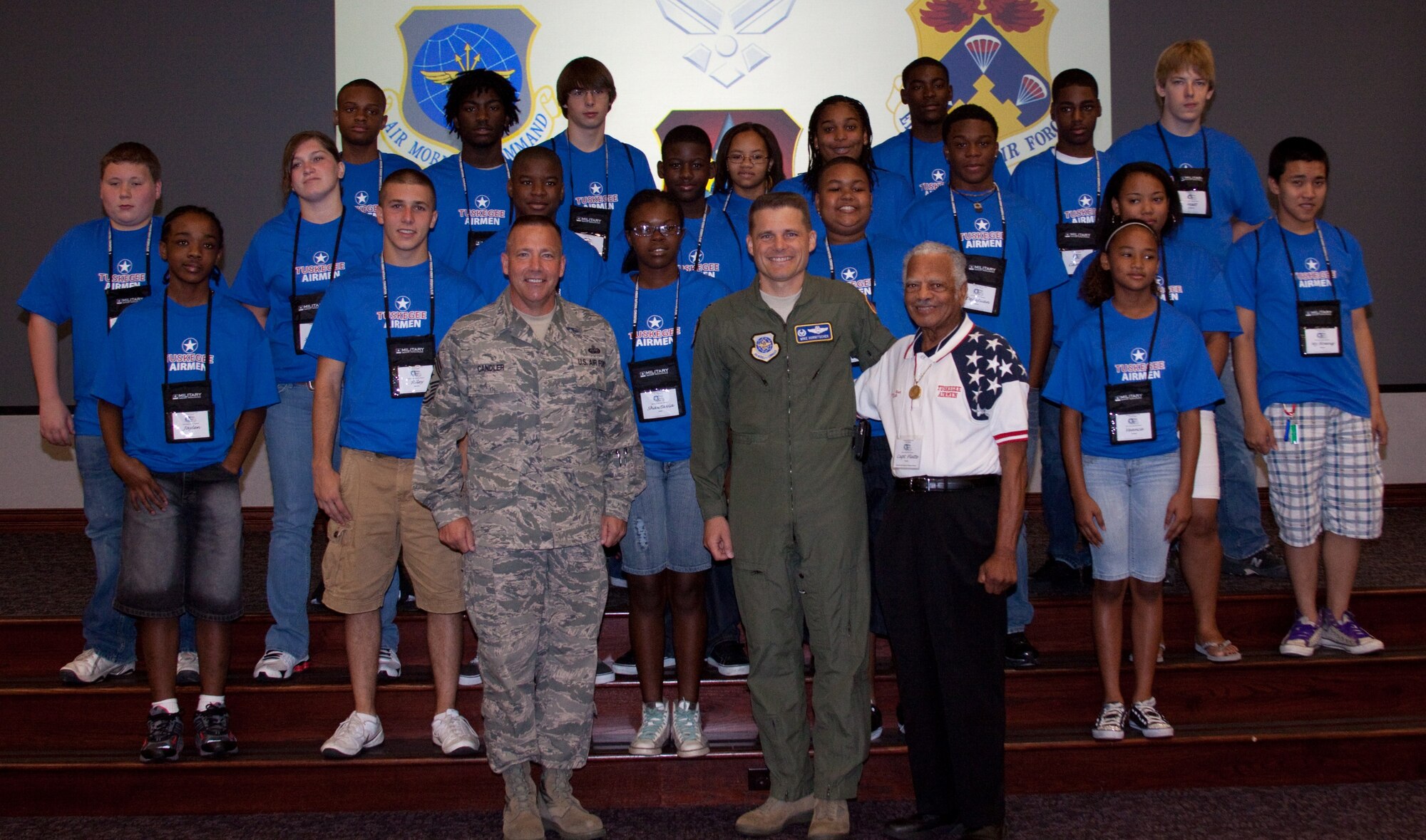 SCOTT AIR FORCE BASE, Ill. -- Front left, Chief Master Sgt. Kevin Candler, 375th Air Mobility Wing command chief; Col. Mike Hornitschek, 375th AMW commander; and retired Capt. Claude Platte, an original Tuskegee Airman, pose with 21 youth during a seminar hosted June 24–26 at Scott.  More than 30 volunteers from across the base teamed up with the Scott Air Force Base Lewis Lynch Tuskegee Airmen Chapter to welcome students from the various states in the central region. Students learned about aviation, military organizations, citizenship responsibility and the history of the Tuskegee Airmen. (U.S. Air Force photo/ Senior Master Sgt. Patrick Jones)