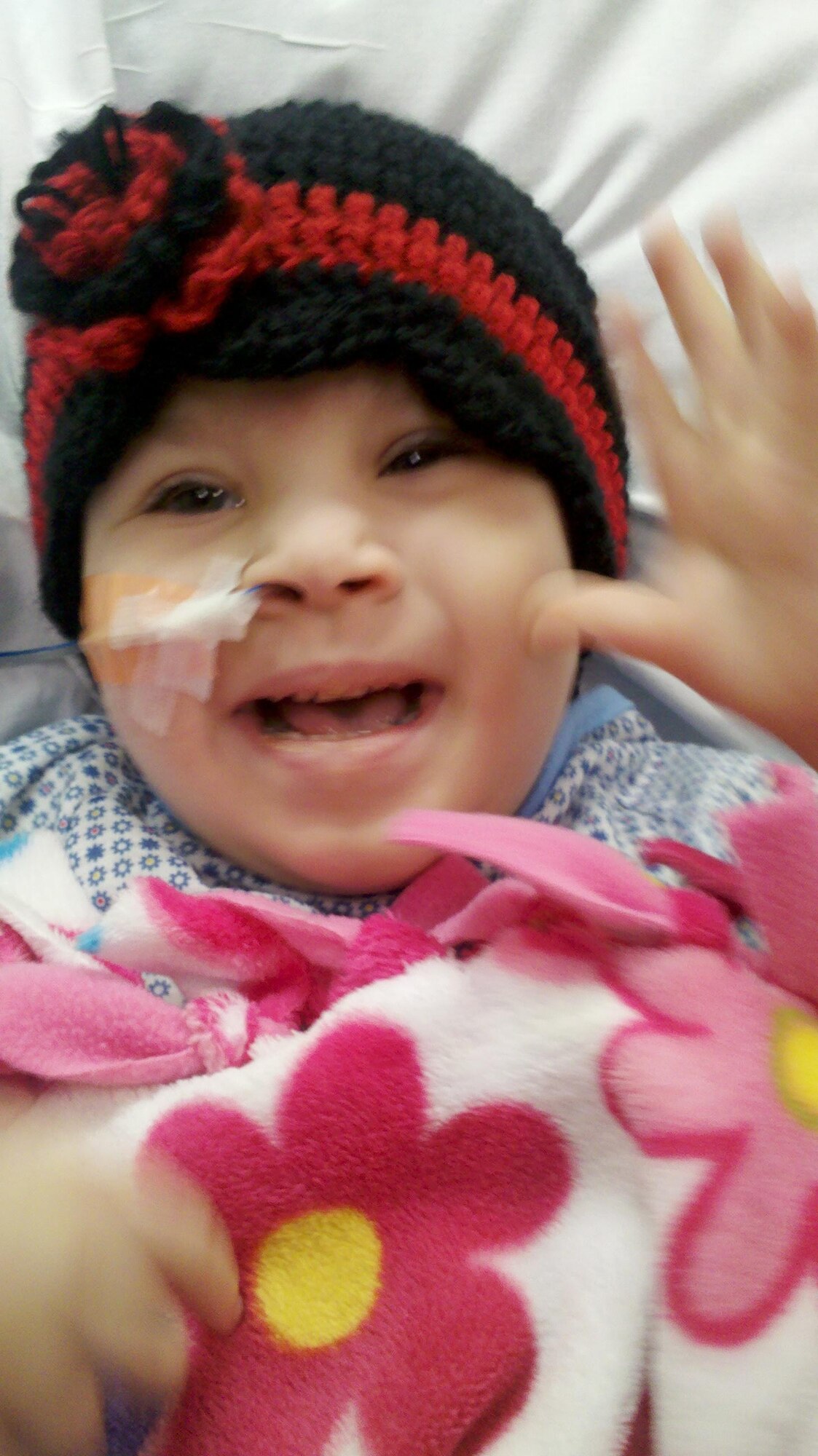 Five-year-old Kaliana, daughter of Master Sgt. Joe and Jenna Herrera, pauses for a moment while in the hospital.  Kaliana has Spina Bifida, a defect that involves the incomplete development of the spinal cord.  Kaliana has endured five surgeries thus far with Sgt. Herrera having left Afghanistan two times on emergency leave to support his family.  Sgt. Herrera is a helicopter crew chief with the 440th Air Expeditionary Advisory Squadron.  (Air Force courtesy photo provided by Master Sgt. Joe Herrera)