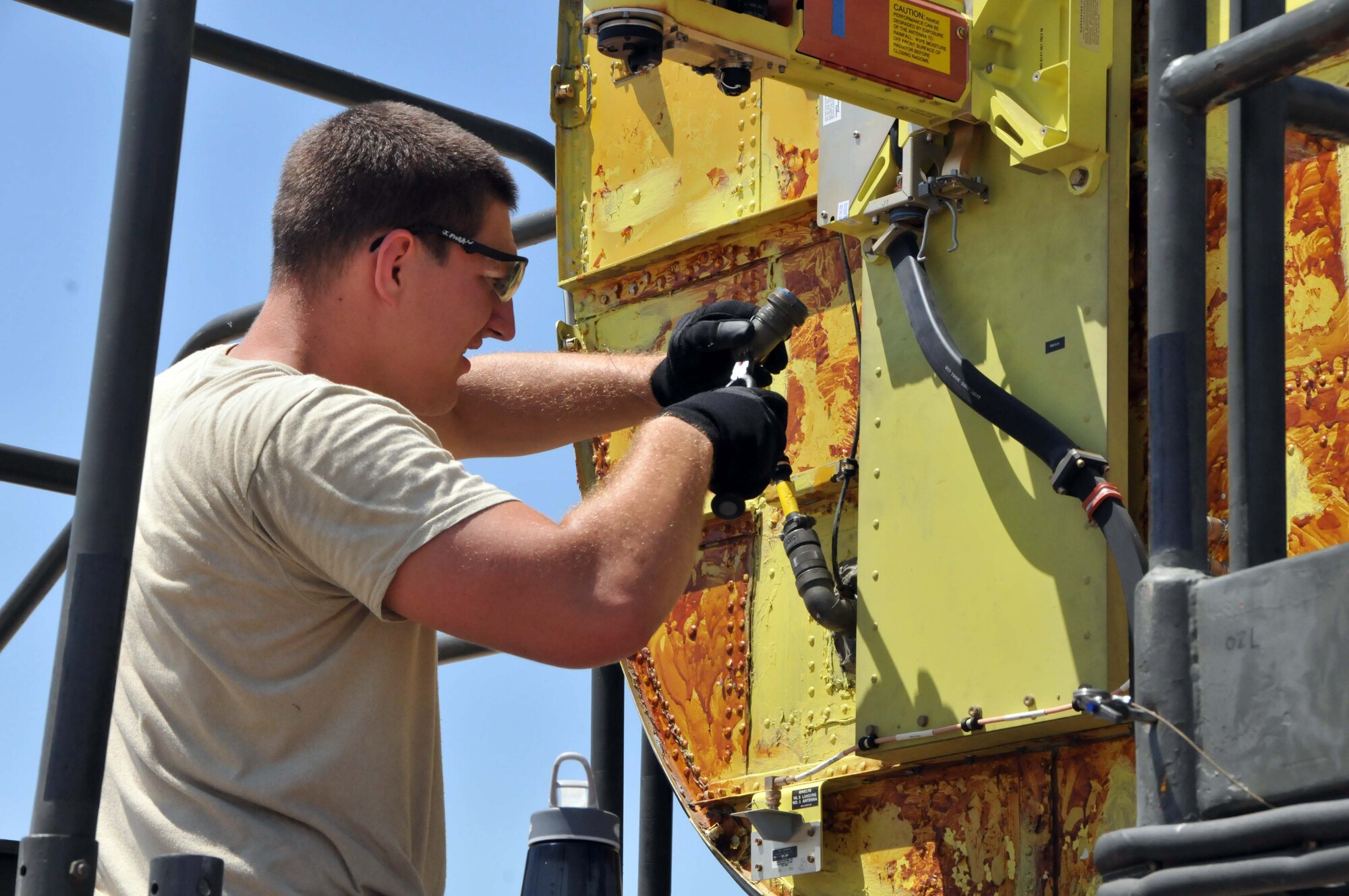 Senior Airman Joseph A. Moran safety wires the antenna pedestal on the color weather radar of a KC-135 Stratotanker at the 313th Air Expeditionary Wing on July 5, 2011, in Western Europe.