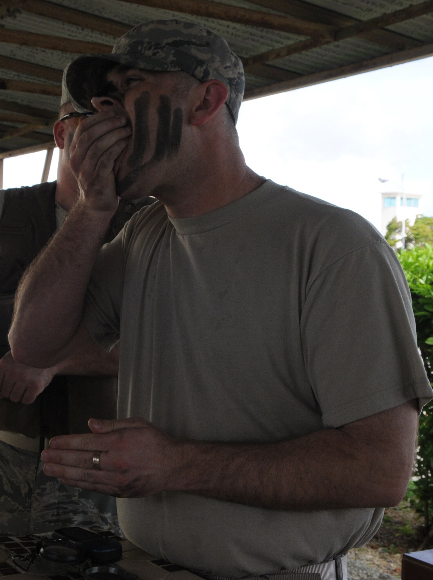 KADENA AIR BASE, Japan -- Tech. Sgt. Brett Priest, from the 373rd Support Squadron at Misawa Air Base, stuffs a cricket in his mouth at a station of an obstacle course during a visit to the 353rd Special Operations Group here July 6. The 353rd SOG hosts students of the Erwin Professional Military Education Center's NCO Academy Air Commando Flight each class. (U.S. photo by Tech. Sgt. Aaron Cram)