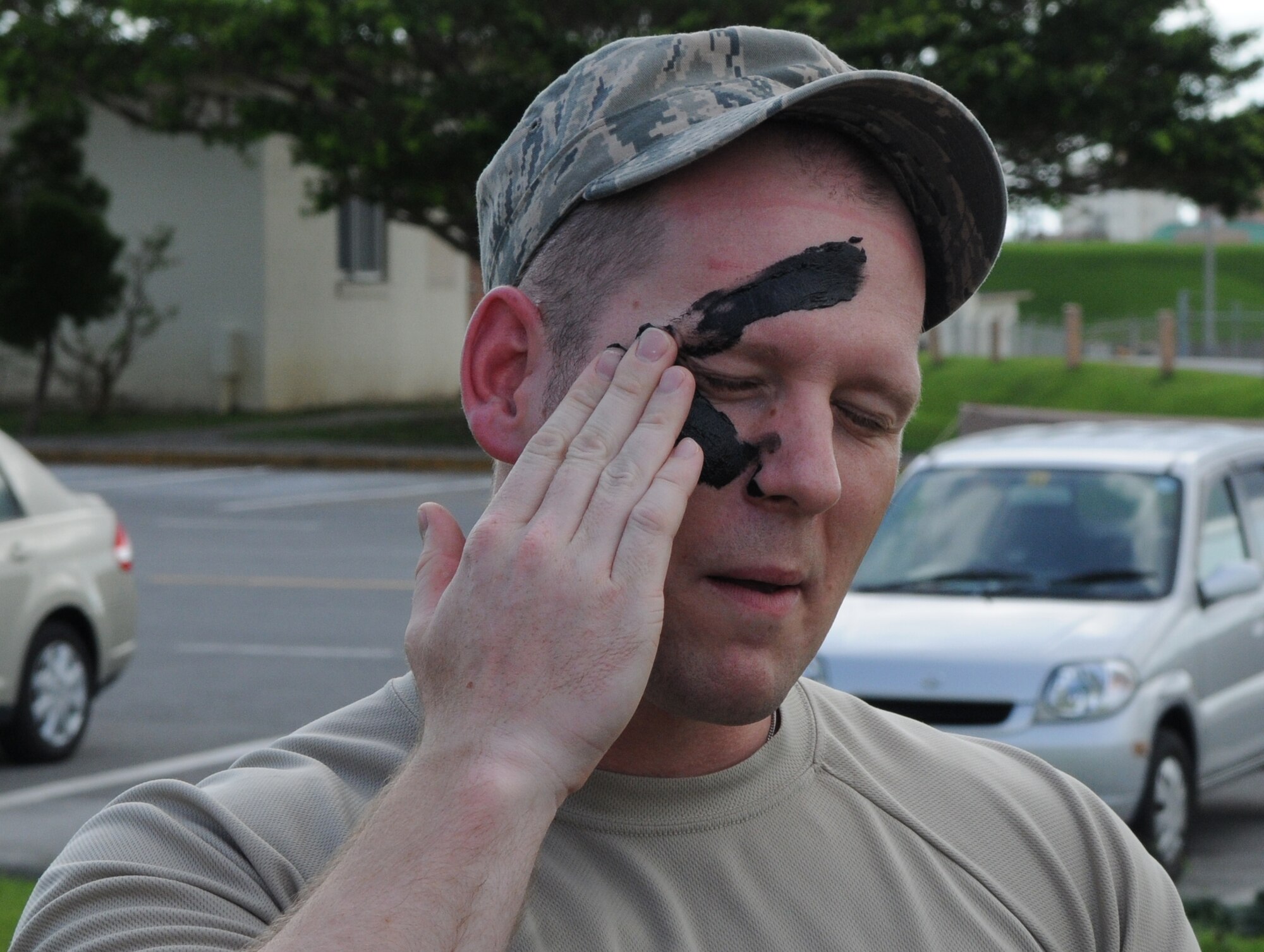KADENA AIR BASE, Japan -- Tech. Sgt. Derek Zarnesky, from the 6th Intelligence Squadron at Osan Air Base, paints his face during a visit to the 353rd Special Operations Group here July 6. The 353rd SOG hosts students of the Erwin Professional Military Education Center's NCO Academy Air Commando Flight each class. (U.S. photo by Tech. Sgt. Aaron Cram)