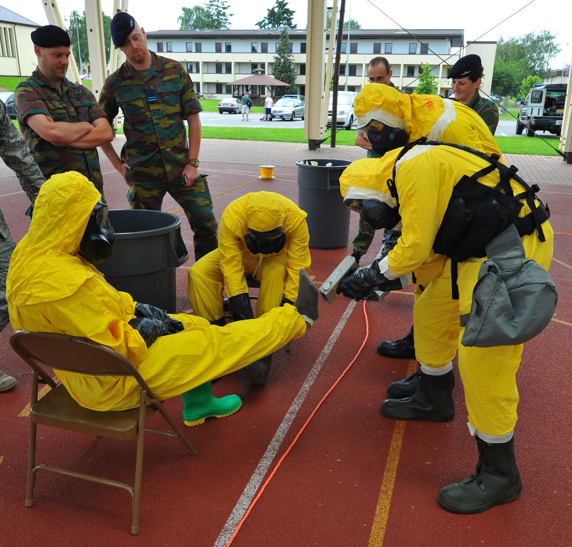 SPANGDAHLEM AIR BASE, Germany – Airmen assigned to the 52nd Civil Engineer Squadron simulate scanning one another for alpha and beta radiation during a decontamination exercise here June 30. Members of the Belgian air force visited to learn about U.S. Air Force decontamination procedures. (U.S Air Force photo/Airman 1st Class Dillon Davis)