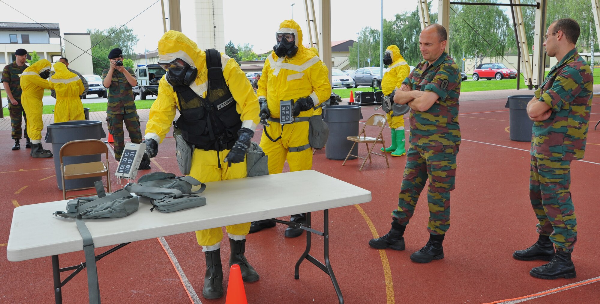 SPANGDAHLEM AIR BASE, Germany – Airmen assigned to the 52nd Civil Engineer Squadron scan gas mask carriers as part of a decontamination exercise here June 30. Members of the Belgian air force visited to learn about U.S. Air Force decontamination procedures. (U.S Air Force photo/Airman 1st Class Dillon Davis)