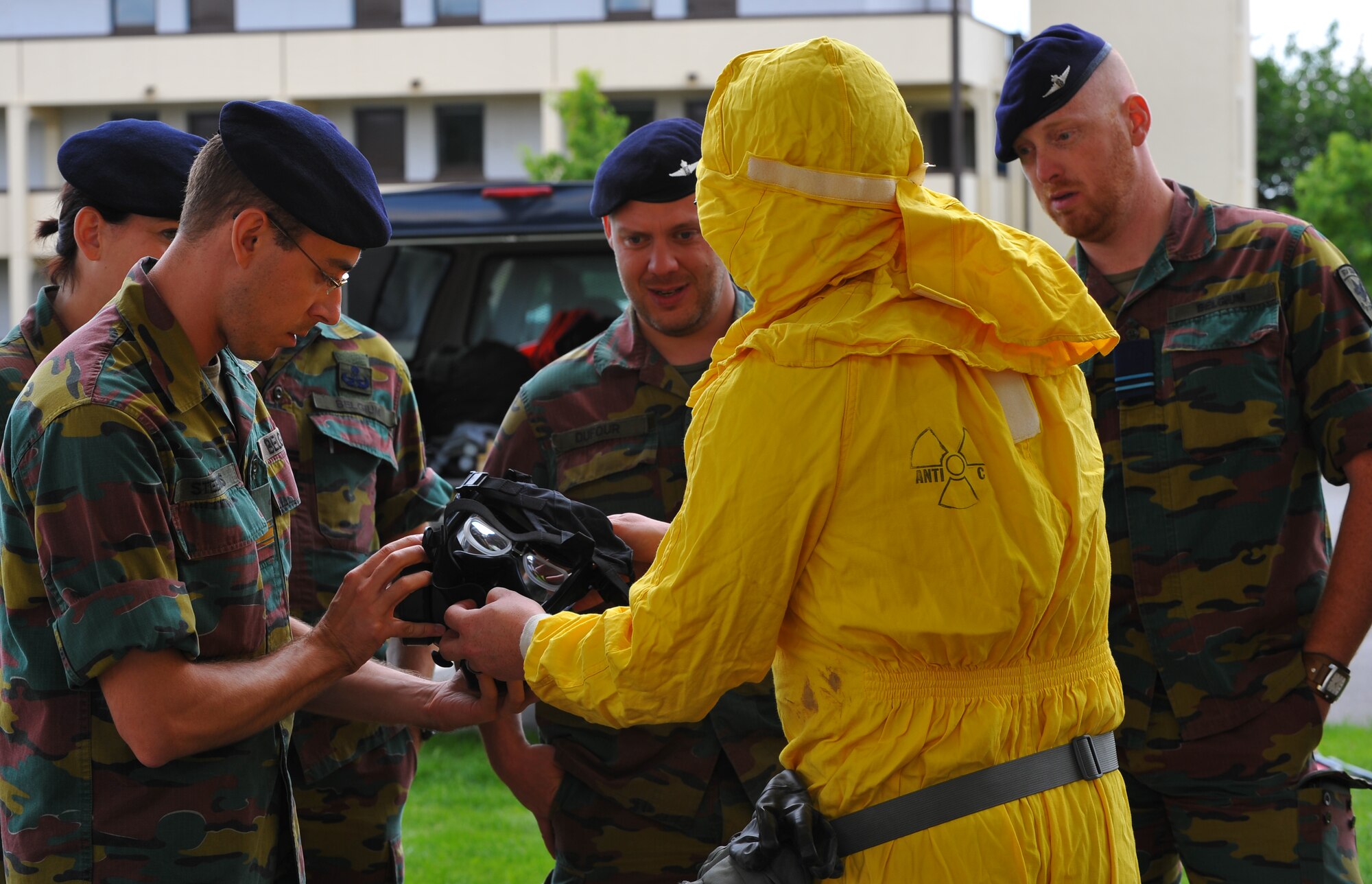 SPANGDAHLEM AIR BASE, Germany – An Airman assigned to the 52nd Civil Engineer Squadron shows the U.S. Armed Forces M50 gas mask to Belgian air force service members here June 30. Members of the Belgian air force visited to learn about U.S. Air Force decontamination procedures. (U.S Air Force photo/Airman 1st Class Dillon Davis)