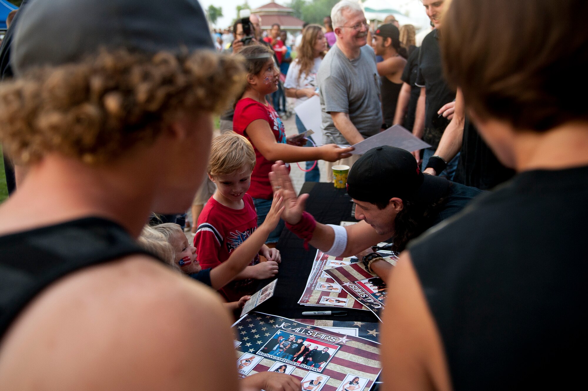 Hard-rock band Matthew JC and the AllStars sign autographs July 2, 2011, at Arkadas Park, Incirlik Air Base, Turkey. The band performed as part of the festivities during an Independence Day Celebration, which also included various activities, food and live entertainment. (U.S. Air Force photo by Tech. Sgt. Michael B. Keller/Released)