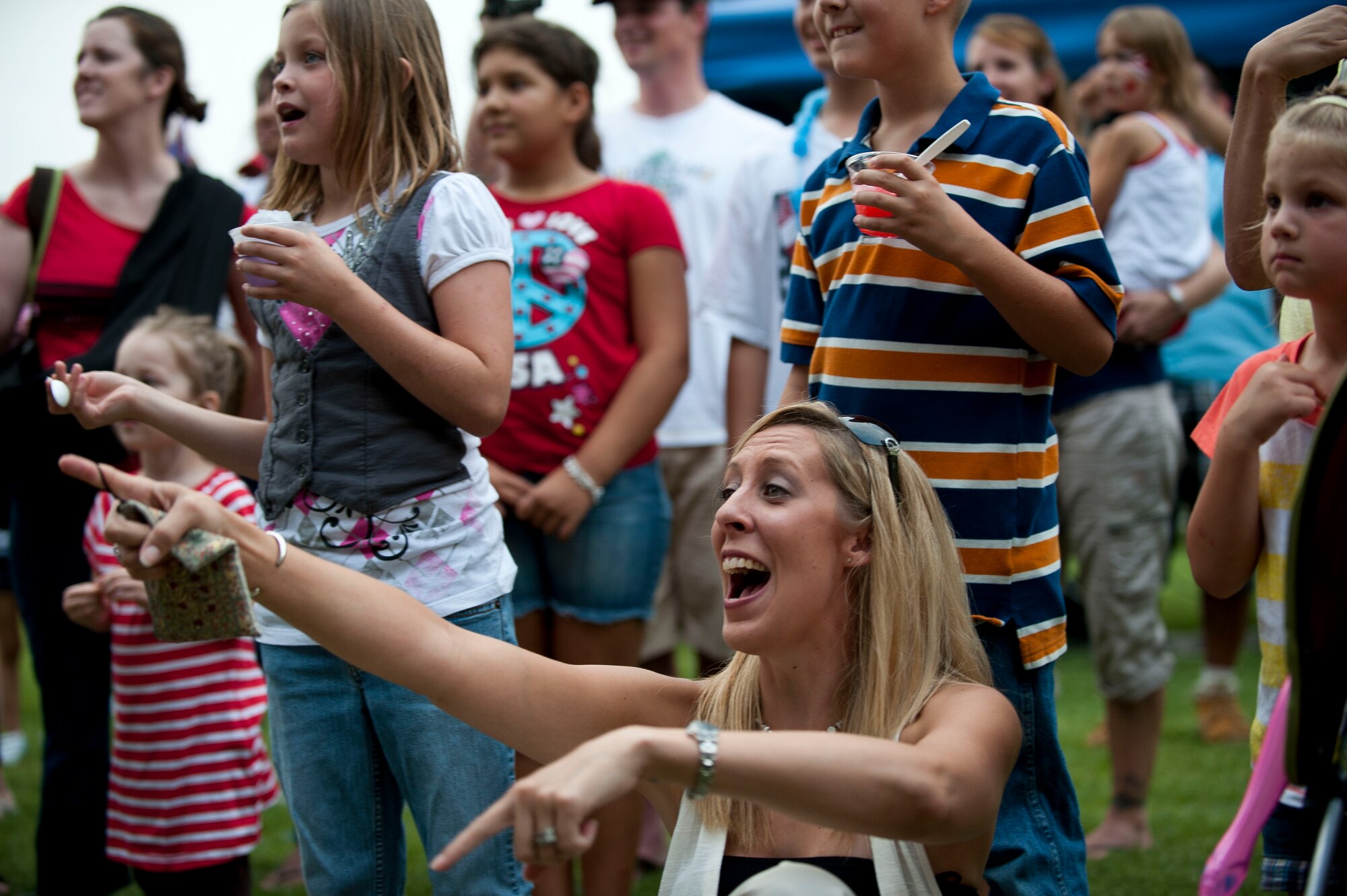 Sarah Haar, wife of Tech. Sgt. Joseph Haar from the 39th Operations Squadron, watches the hot dog eating contest July 2, 2011, at Arkadas Park, Incirlik Air Base, Turkey. Team Incirlik celebrated Independence Day with various activities, food and live entertainment. (U.S. Air Force photo by Tech. Sgt. Michael B. Keller/Released)