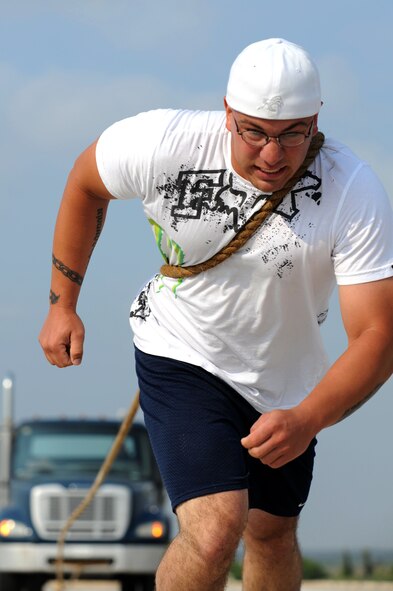 A member of Team Incirlik pulls a truck during the strongman competition during Independence Day celebrations July 2, 2011, at Arkadas Park, Incirlik Air Base, Turkey. Other activities included a hot dog eating competition, live music and fireworks. (U.S. Air Force photo by Airman 1st Class Clayton Lenhardt/Released)