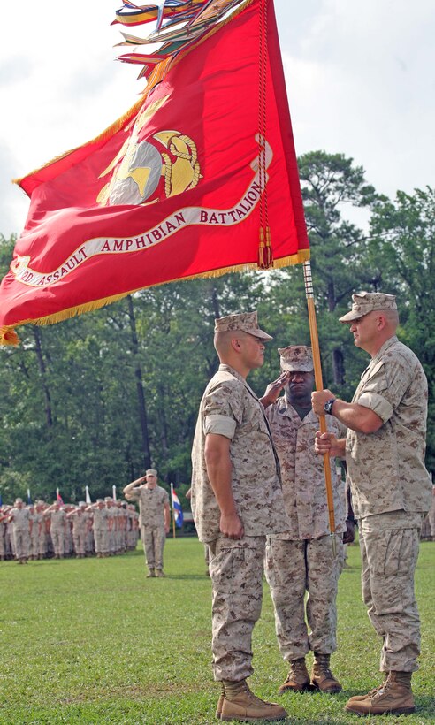 Lt. Col. Joseph C. Murray holds the unit colors as he relinquishes his duties as commanding officer of 2nd Assault Amphibian Battalion, 2nd Marine Division, to Lt. Col. Patrick W. McCuen during a change of command ceremony July 8, 2011, aboard Marine Corps Base Camp Lejeune, N.C. As part of the ceremonial tradition, it is customary to pass the unit colors to the oncoming commanding officer.