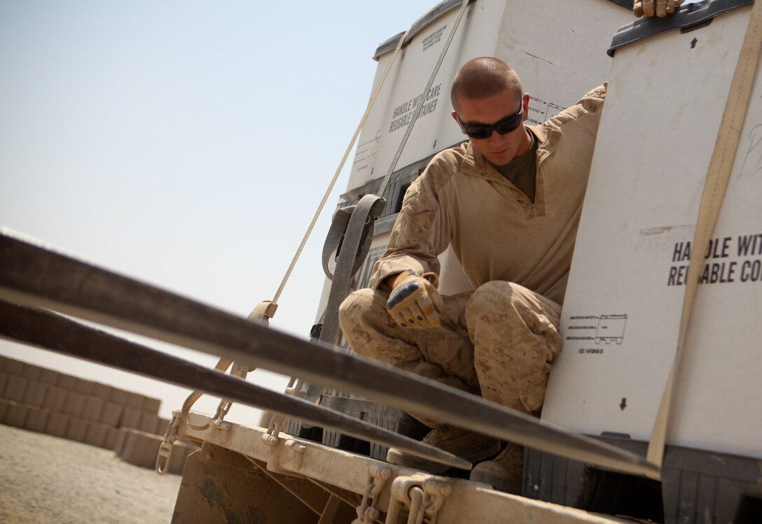 Pendleton, Ind., native Lance Cpl. John Gaw guides a small tractor into place during a recent convoy mission. The motor transport operator with the logistics train for 3rd Battalion, 2nd Marine Regiment, drives a 7-ton vehicle that carries thousands of pounds of supplies on a daily basis. ::r::::n::::r::::n::::r::::n::