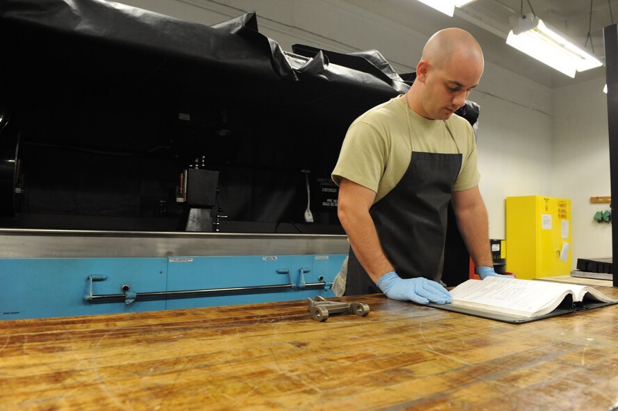Airman 1st Class Paul Nessle, 2nd Maintenance Squadron, reads a technical order in the 2nd Propulsion Flight building on Barksdale Air Force Base, La., July 8. The guide is used to assist Airmen while operating the Magnetic Particle Bench and other equipment. (U.S. Air Force photo/Airman 1st Class Micaiah Anthony)(RELEASED)