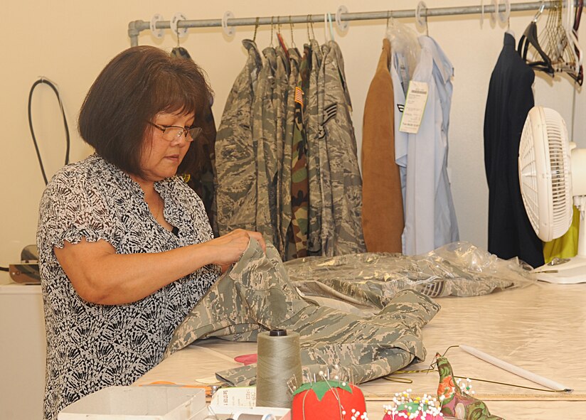 Tam Harper, 2nd Services Squadron, sews stripes on a uniform in the new alterations shop in Military Clothing Sales on Barksdale Air Force Base, La., July 7. Alterations is a new addition to the Military Clothing Sales Base Exchange location. (U.S. Air Force photo/Senior Airman Kristin High)(RELEASED)