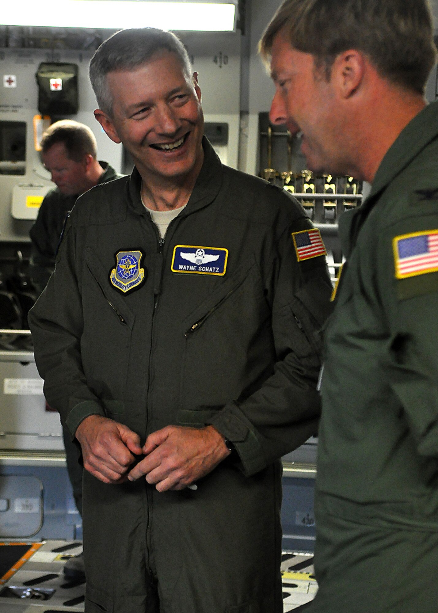 Brig. Gen. Wayne Schatz, left, Air Mobility Command Director of Strategic Plans, Requirements and Programs, shares a laugh with Col. R. Wyn Elder, 62nd Airlift Wing commander, after the delivery of McChord Field’s newest C-17 Globemaster III July 7 at Joint Base Lewis-McChord, Wash. (U.S. Air Force photo/Airman 1st Class Leah Young)