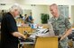 Larry DeMars gives change to one of his regulars, Airman 1st Class Austin Groupp, 2nd Maintenance Squadron, after a haircut at the main barbershop in the Base Exchange on Barksdale Air Force Base, La., July 8. DeMars has cut hair here for more than 30 years. (U.S. Air Force photo/Senior Airman Chad Warren)(RELEASED)