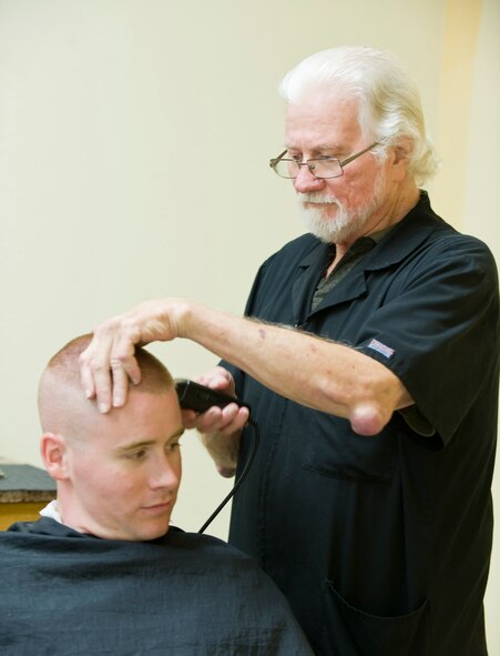 Larry DeMars gives a haircut to one of his regulars, Airman 1st Class Austin Groupp, 2nd Maintenance Squadron, at the main barbershop in the Base Exchange on Barksdale Air Force Base, La., July 8. DeMars has been cutting hair for the military through every conflict since the Vietnam War. (U.S. Air Force photo/Senior Airman Chad Warren)(RELEASED)