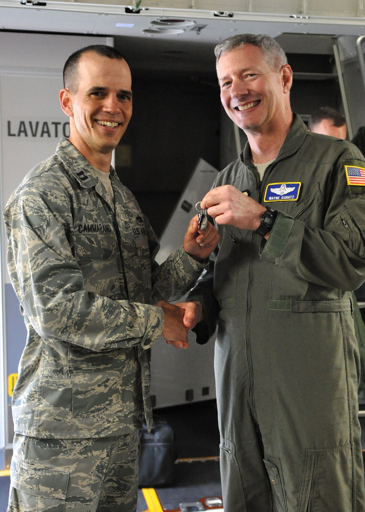 Capt. Vincent Cammarano, left, 62nd Airlift Wing Aircraft Maintenance Squadron, receives the key to McChord Field’s newest C-17 Globemaster III from Brig. Gen. Wayne Schatz, Air Mobility Command Director of Strategic Plans, Requirements and Programs.  (U.S. Air Force photo/Airman 1st Class Leah Young)