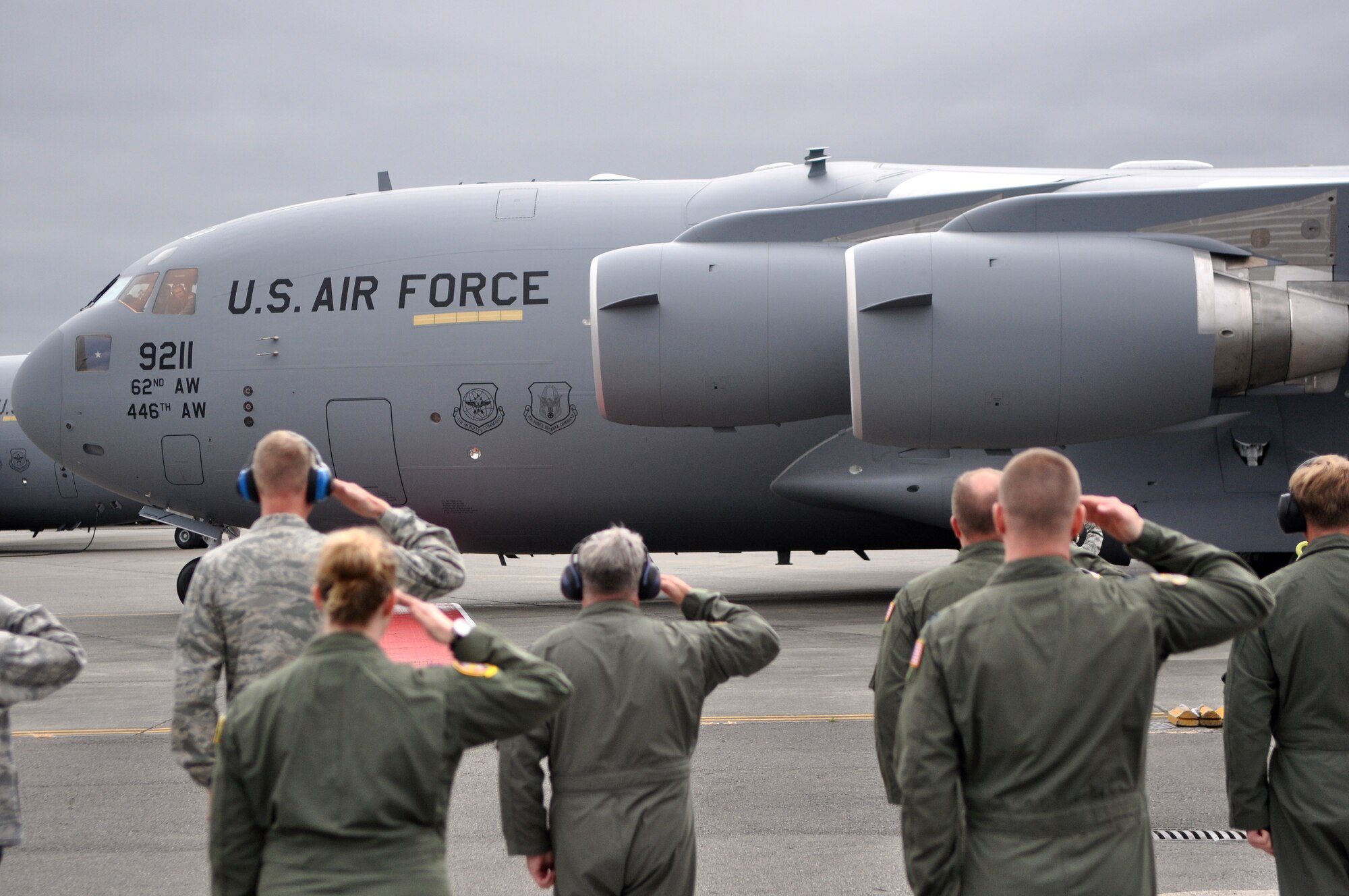 Leaders from the 62nd Airlift Wing salute McChord Field's newest C-17 Globemaster III as it taxis down the runway July 7 at Joint Base Lewis-McChord, Wash. On board was Brig. Gen. Wayne Schatz, Air Mobility Command Director of Strategic Plans, Requirements and Programs.  (U.S. Air Force photo/Airman 1st Class Leah Young)